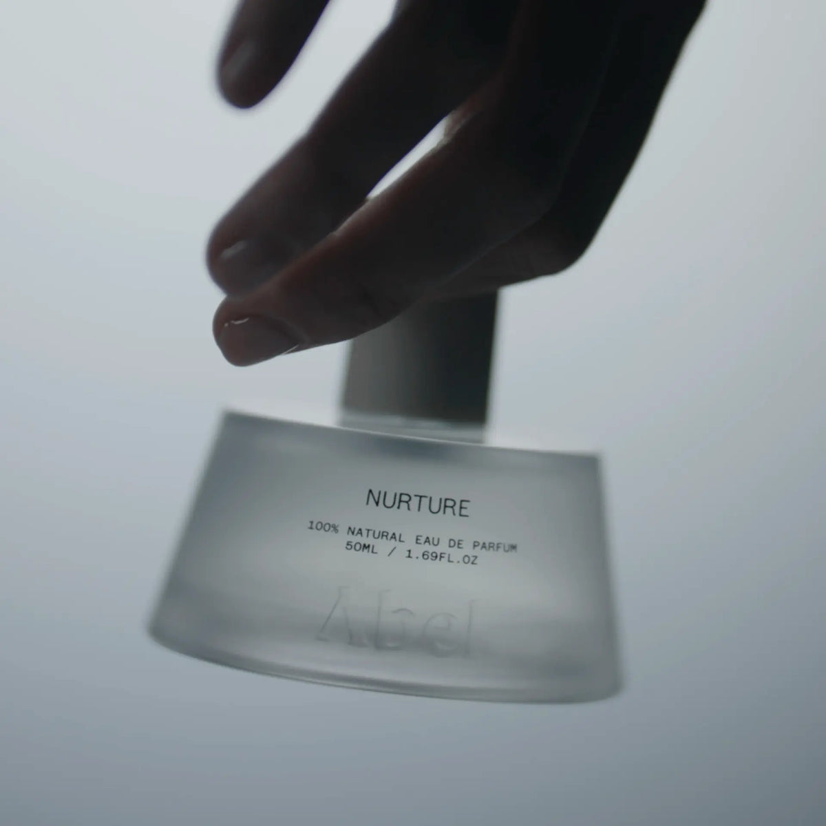 ABEL Nurture 50 ml 100% Natural Eau de Parfum bottle with hand reaching above