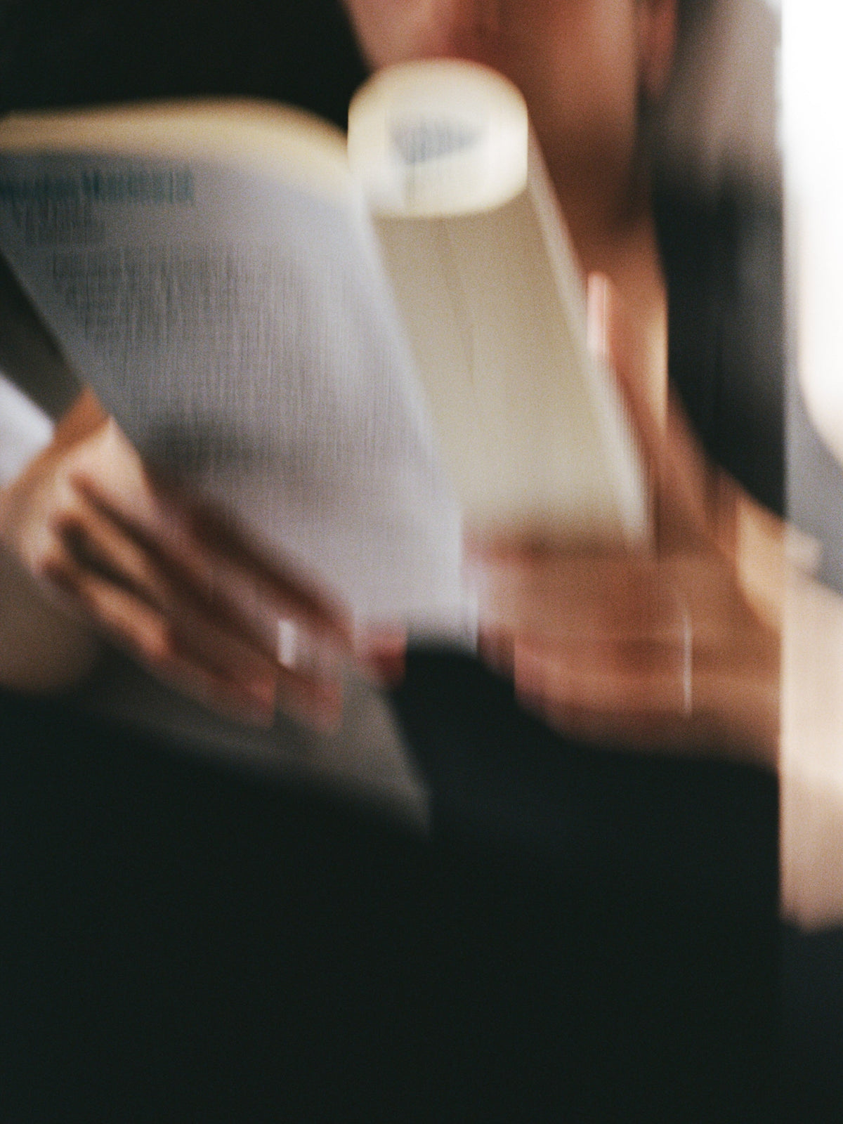 Person reading a book inspired by ABEL The Apartment Eau de Parfum