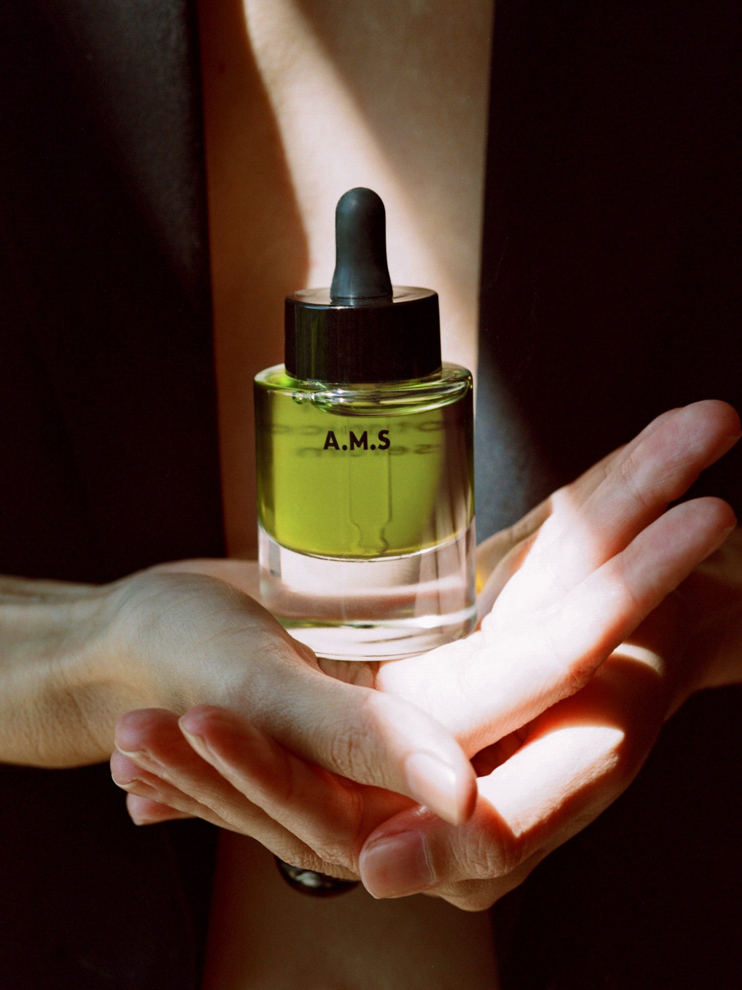 Activist Manuka A.M.S Green Serum bottle held in hands