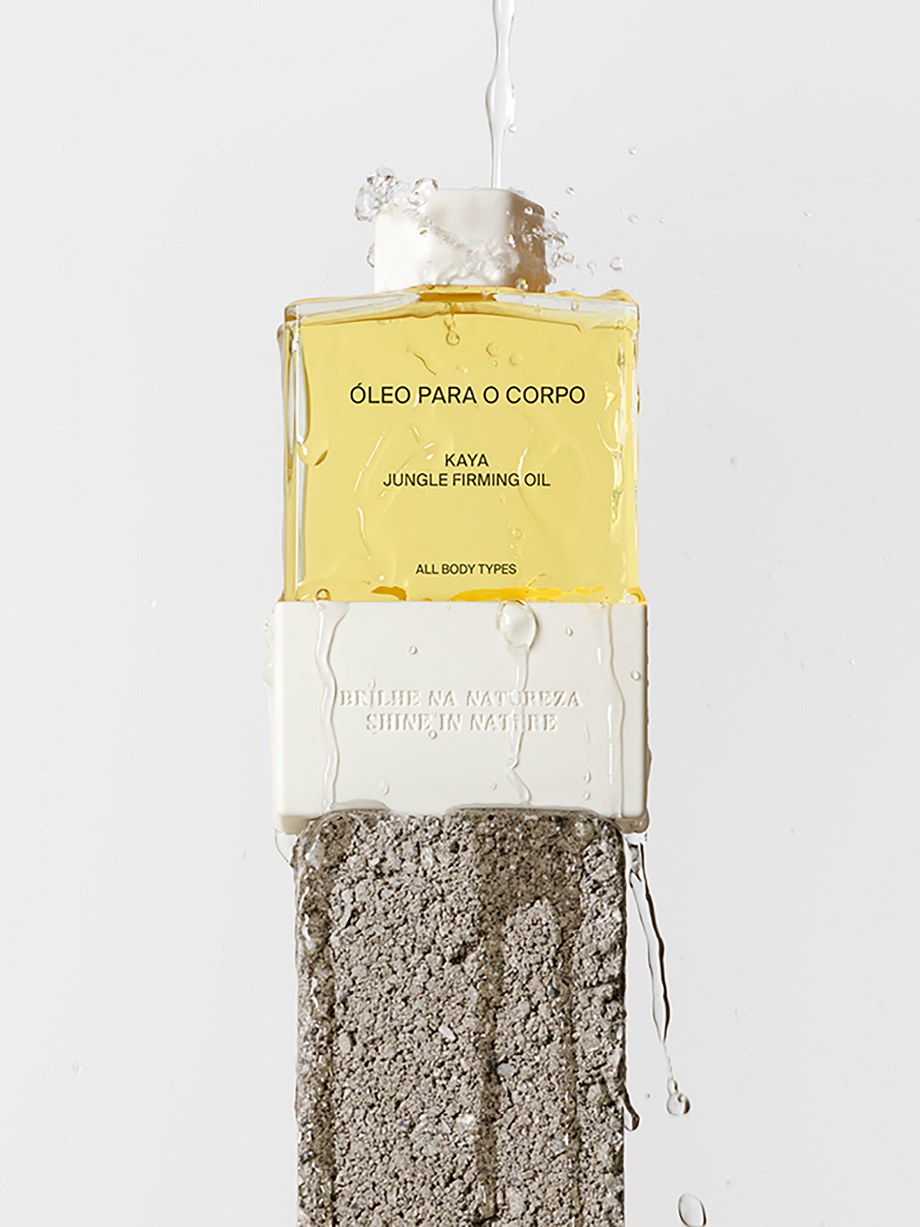 COSTA BRAZIL Kaya Jungle Firming Body Oil all body types lifestyle image bottle standing on stone pedestal