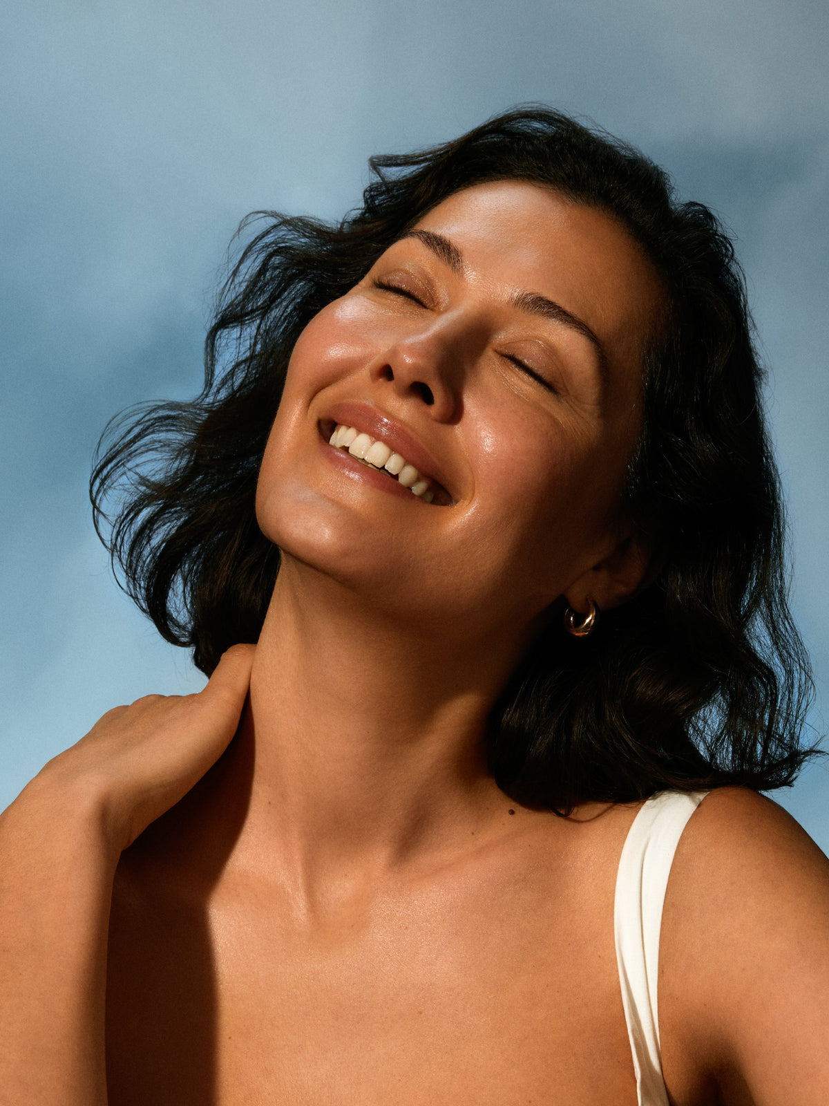 Woman with glowing skin using IRENE FORTE Helichrysum Hydrating Toner