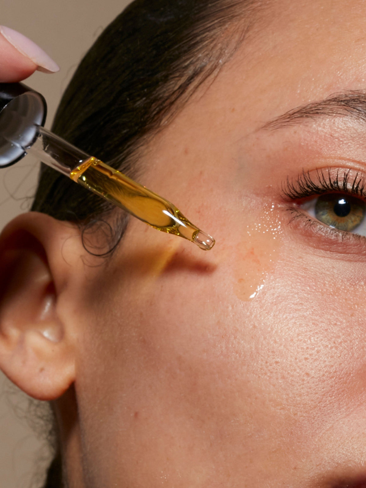 Le Prunier Plum Beauty Oil applied to the face with a dropper for radiant, hydrated skin