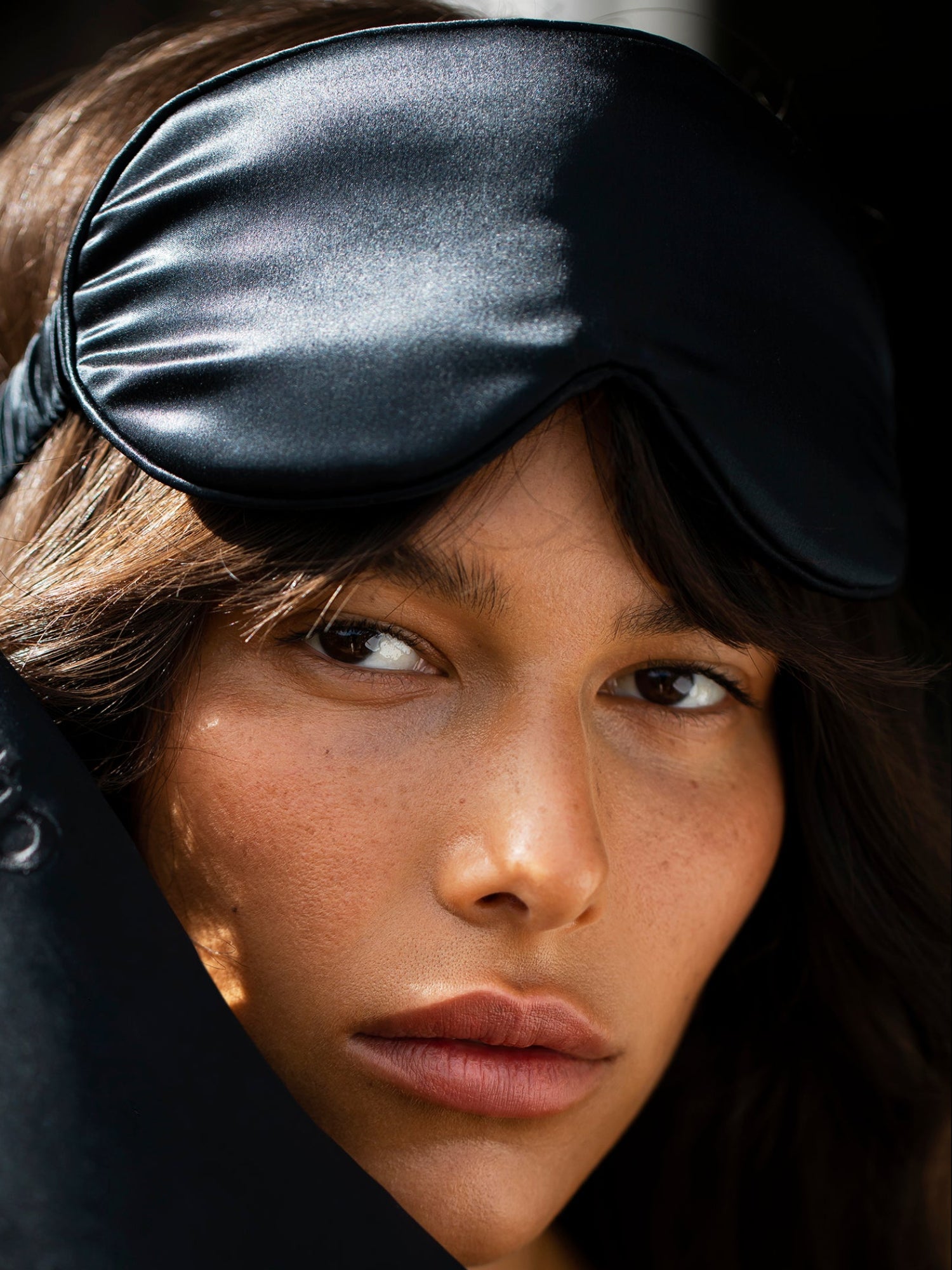 SLIP Sleep Mask in Black – woman wearing a black silk sleep mask