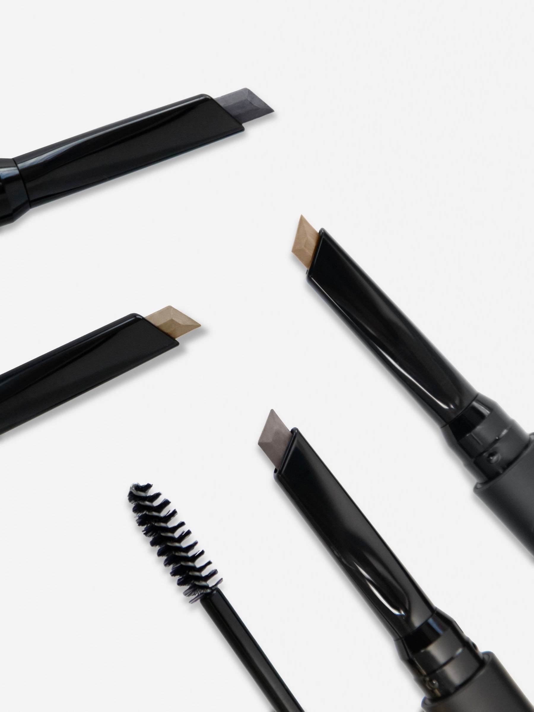 WESTMAN ATELIER Bonne Brow Defining Pencil Lifestyle Image showing all four colors and the eyebrow brush