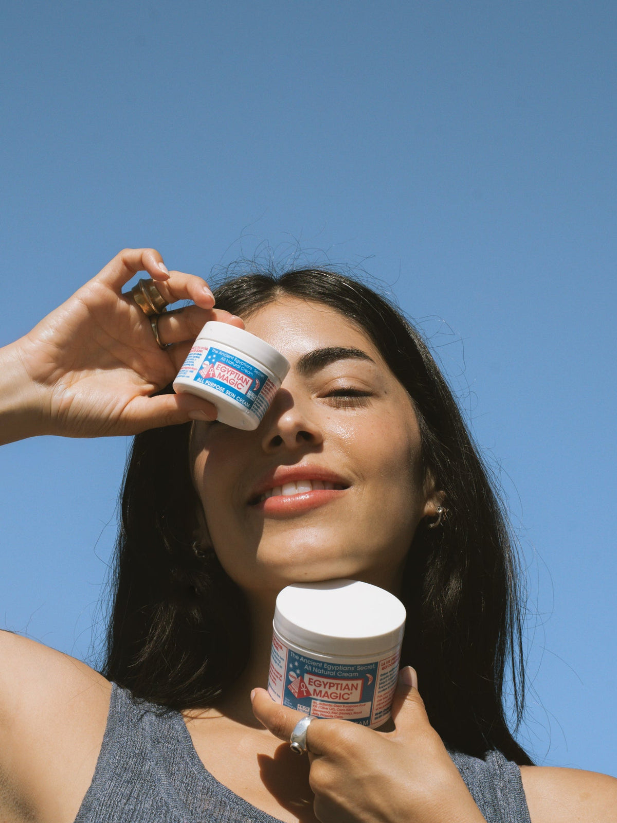 Egyptian Magic All Purpose Skin Cream jars held in hands