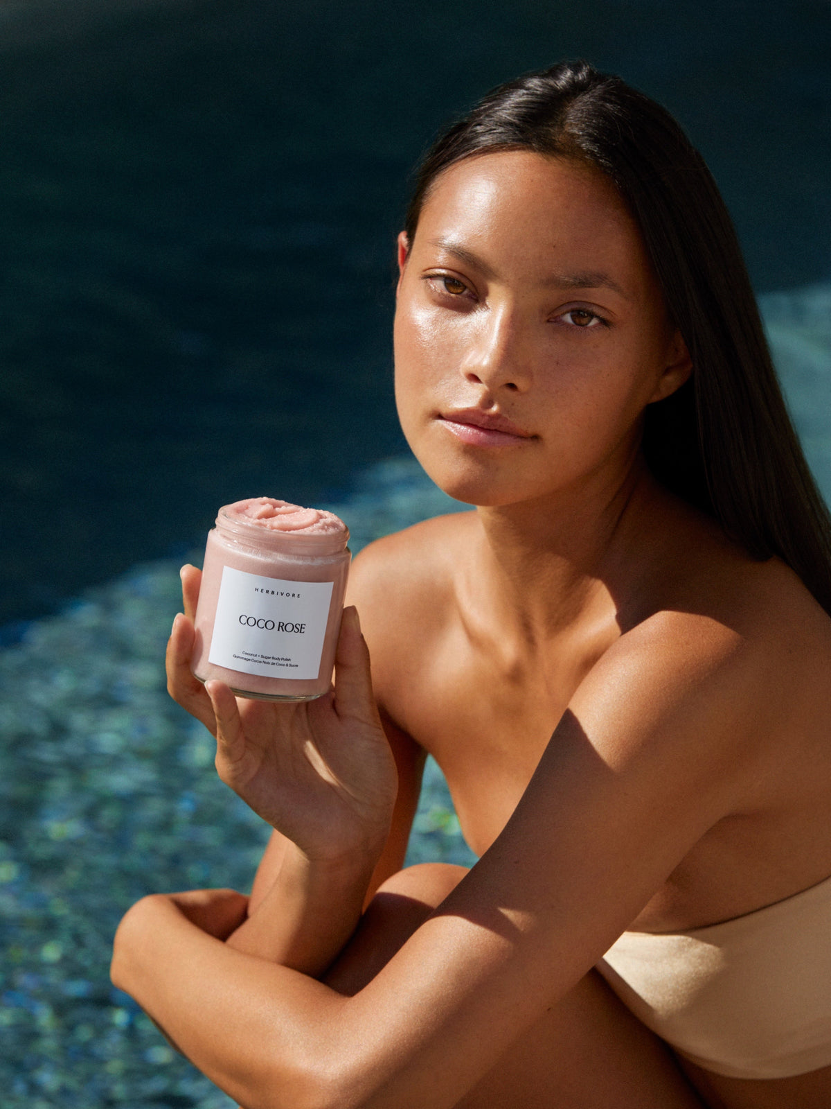 Woman holding Herbivore Botanicals Coco Rose Coconut Oil Body Polish