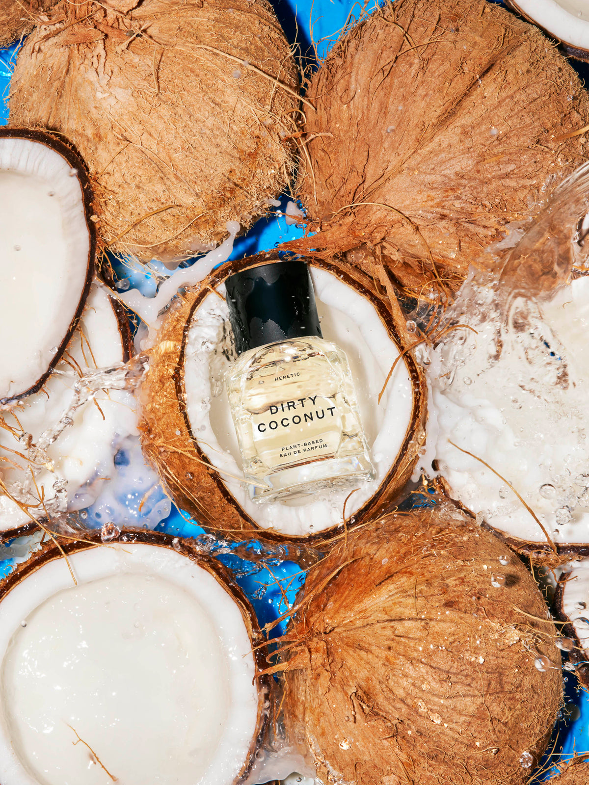 Heretic Parfum Dirty Coconut 50ml Eau de Parfum surrounded by coconuts