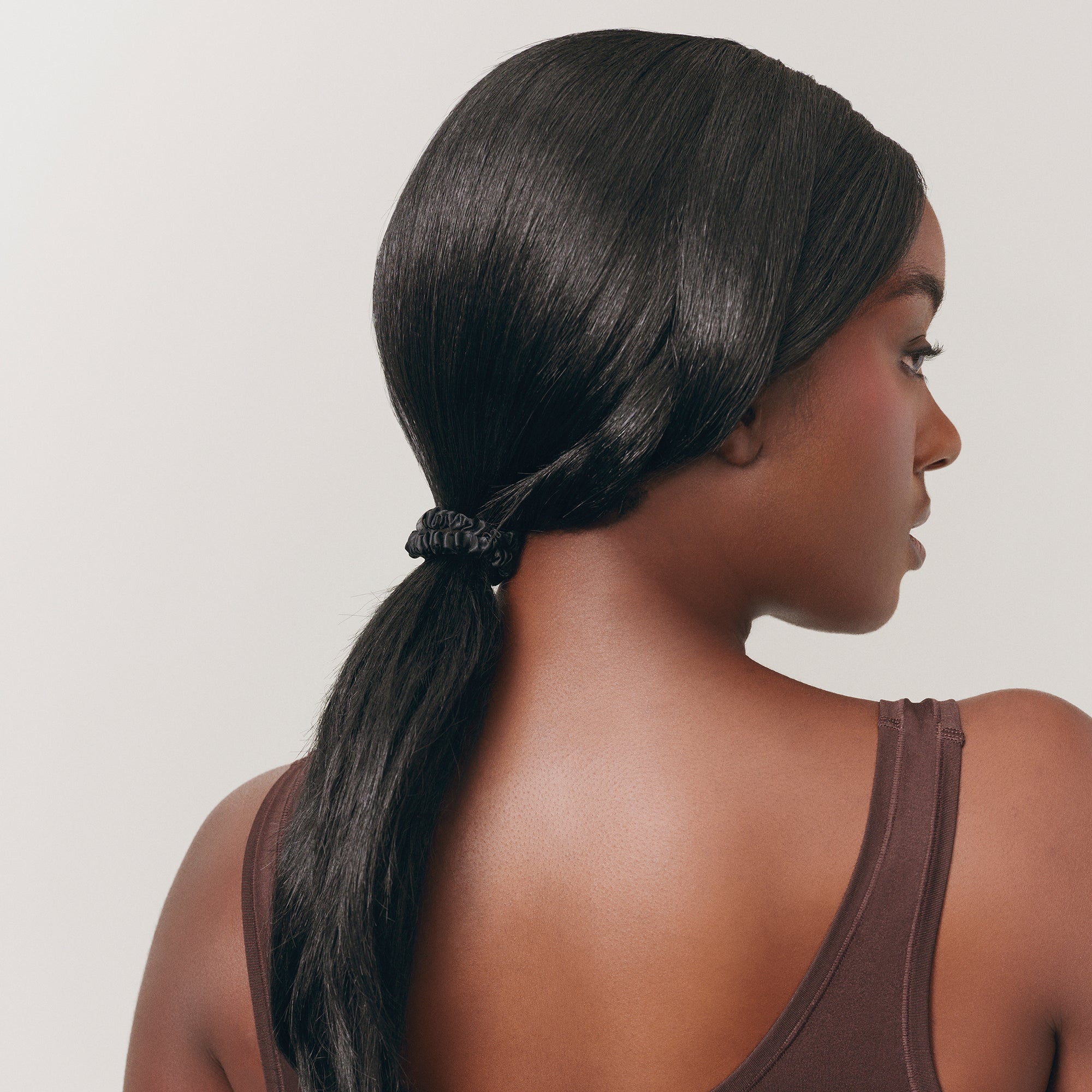 SLIP Black silk hair tie styled in model's hair
