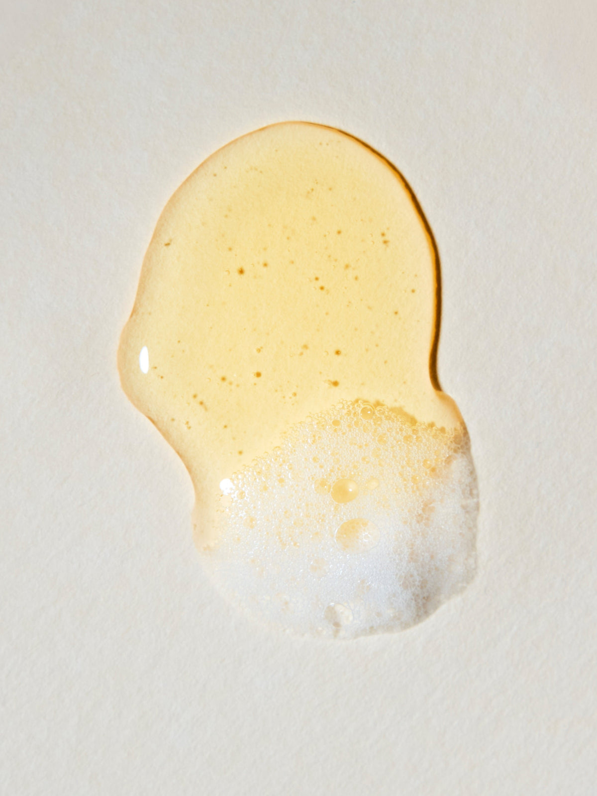 Rahua Classic Shampoo texture with a golden gel and creamy lather