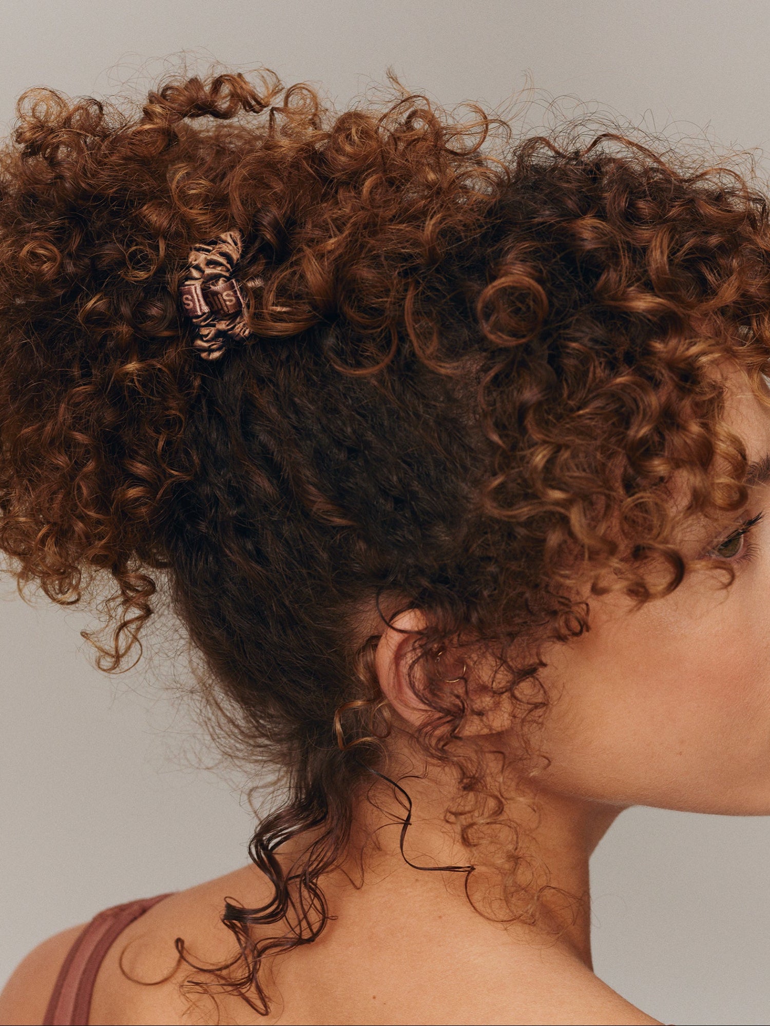 SLIP Back To Basics Skinny Scrunchie in Light Brown worn in curly hair