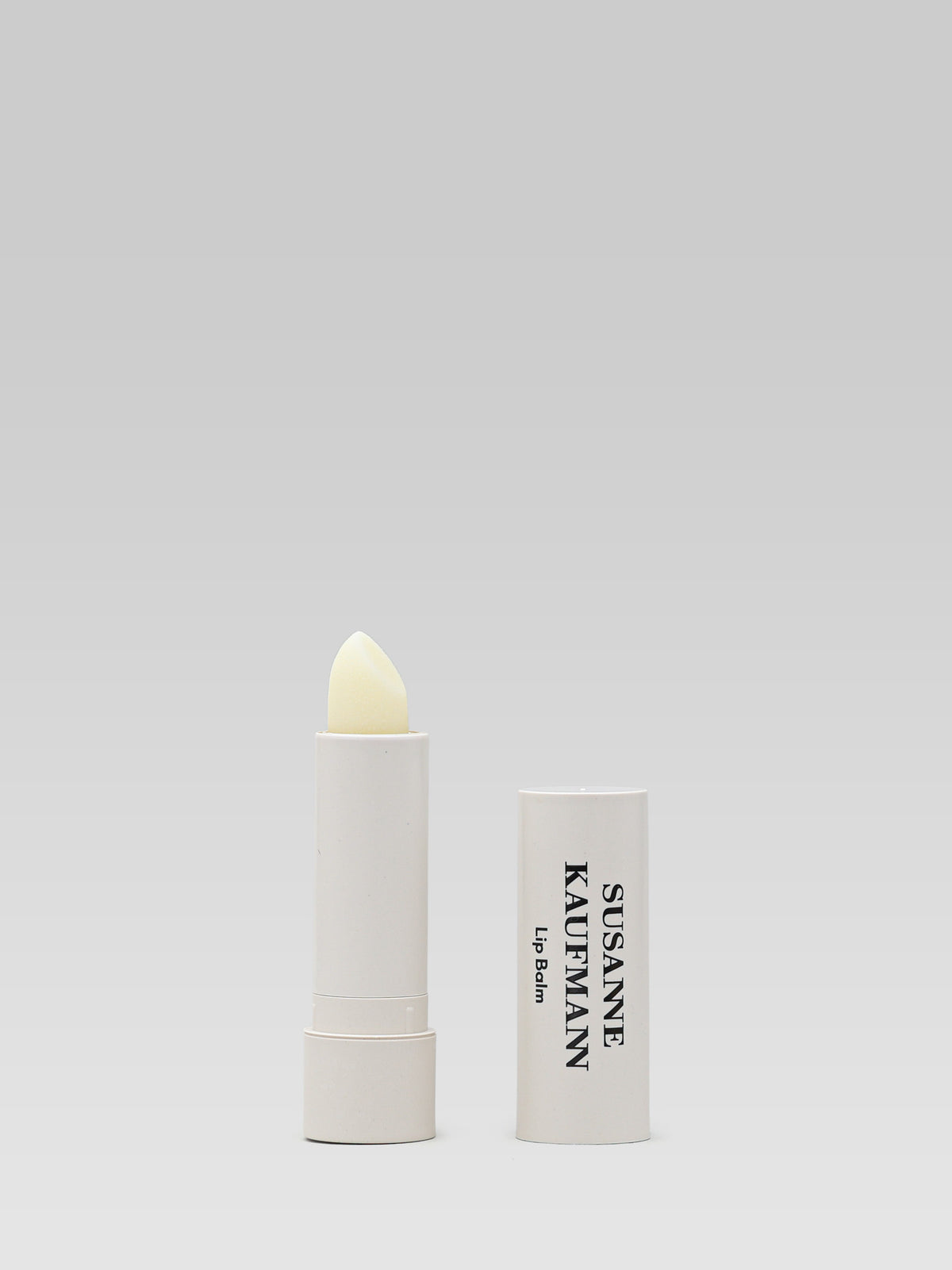 Susanne Kaufmann Lip Balm 3.5 g in a white balm stick with the cap beside it