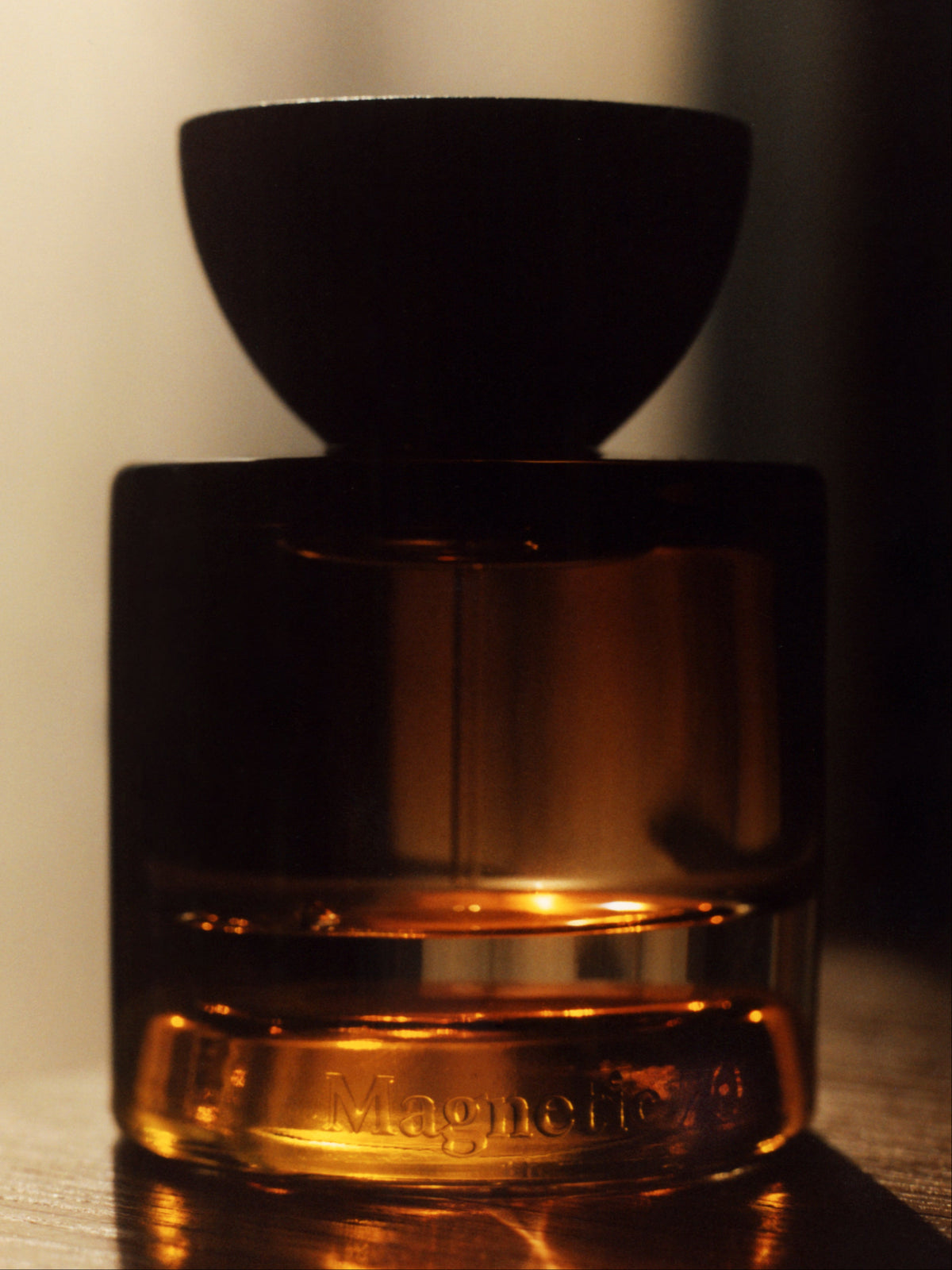 VYRAO Magnetic 70 Eau de Parfum bottle in warm golden light