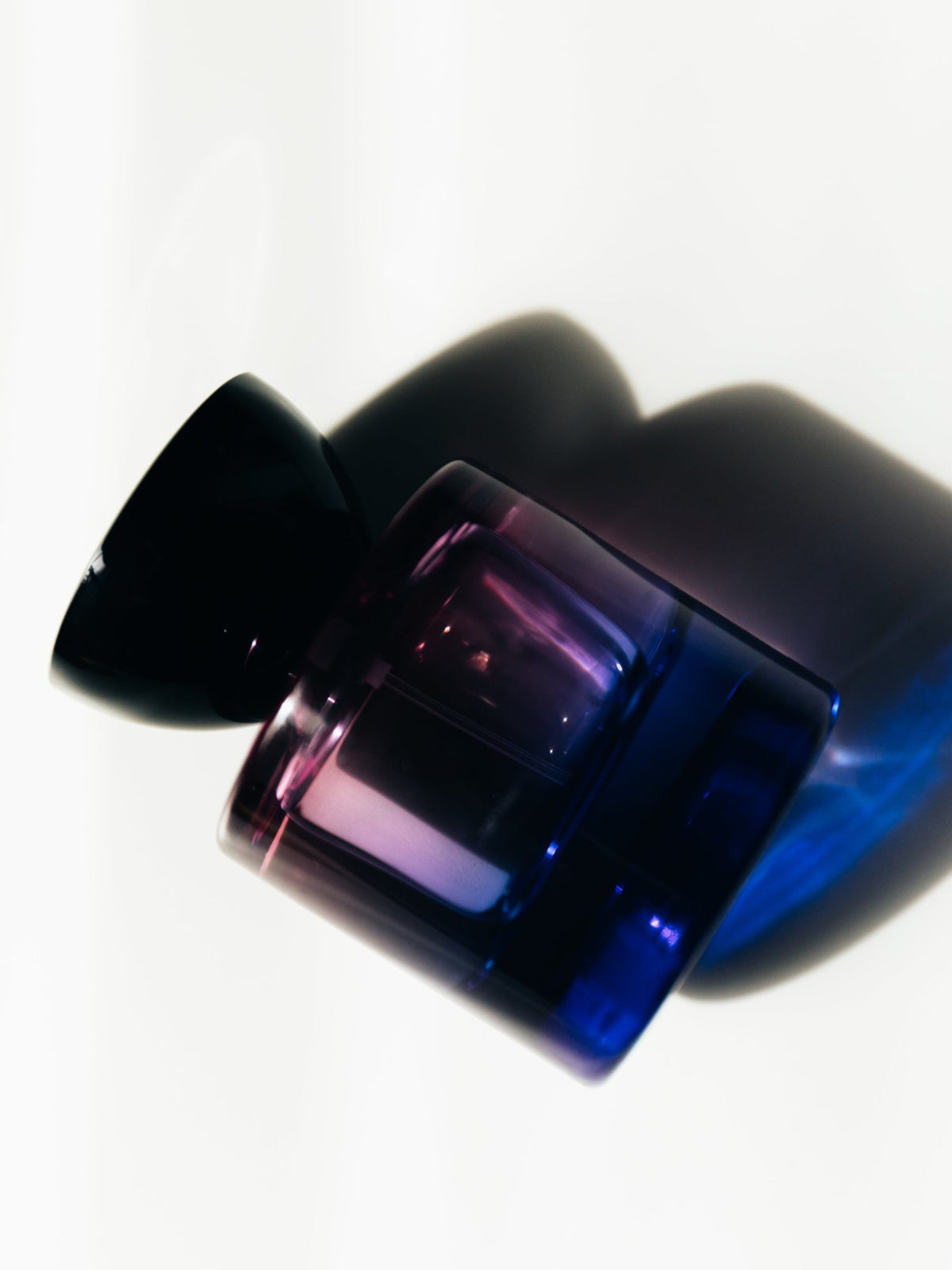 Vyrao Witchy Woo Eau de Parfum bottle in blue and purple light