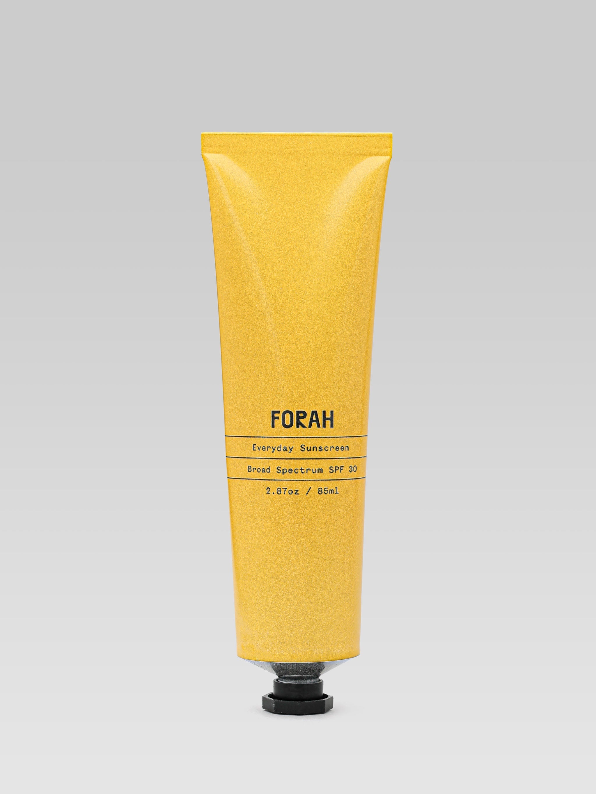 Image of the FORAH Everyday Sunscreen, yellow metal tube on light gray background