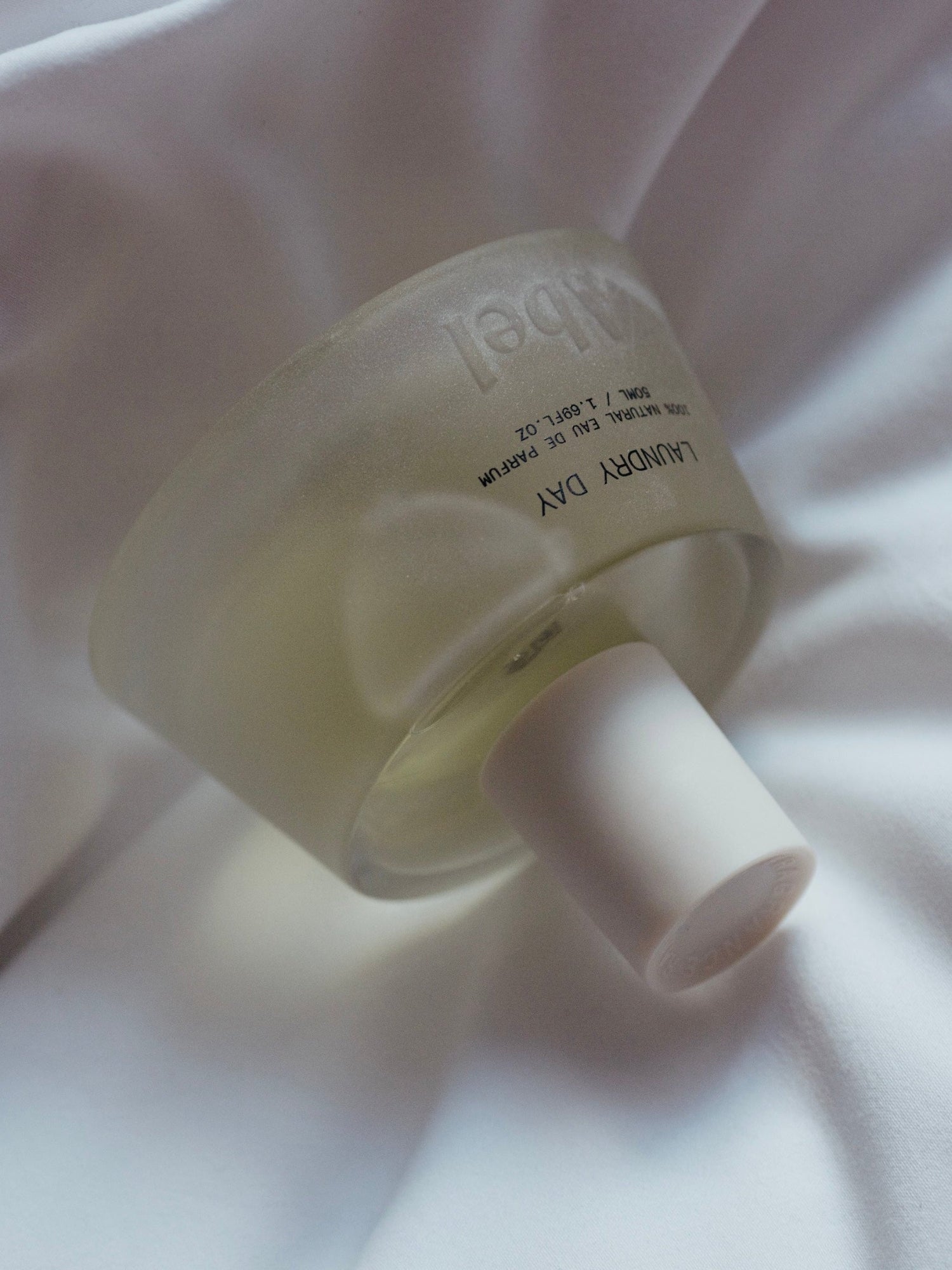 Abel Laundry Day natural eau de parfum bottle on crisp white bed linen