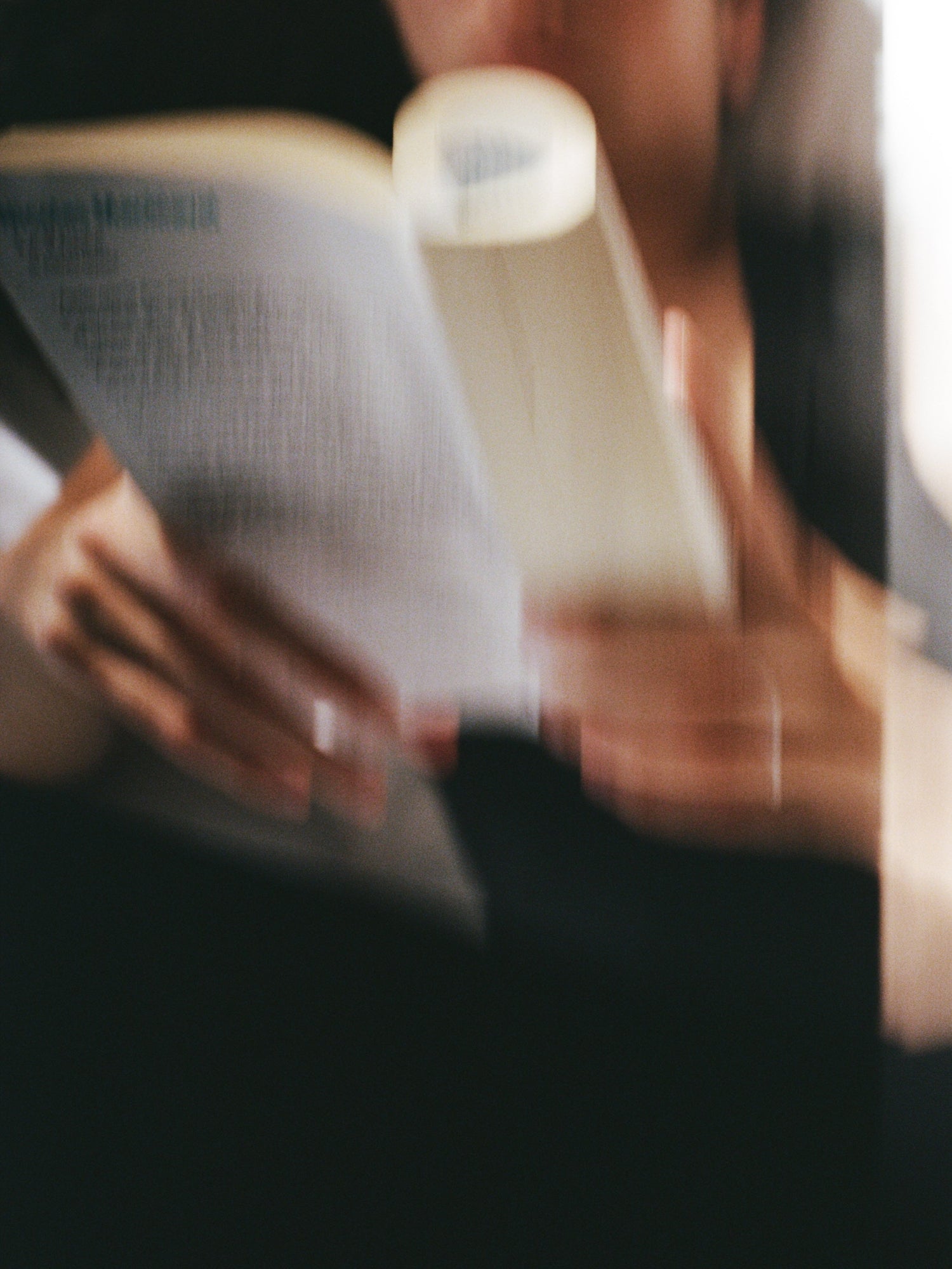 Person reading a book inspired by ABEL The Apartment Eau de Parfum