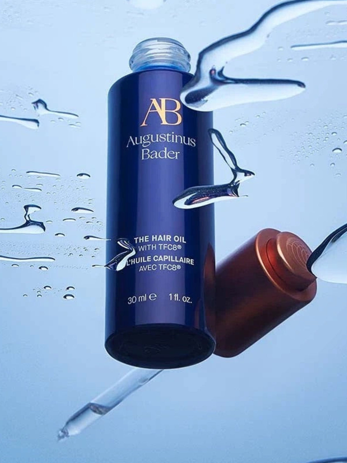 Augustinus Bader The Hair Oil with TFC8 bottle surrounded by water