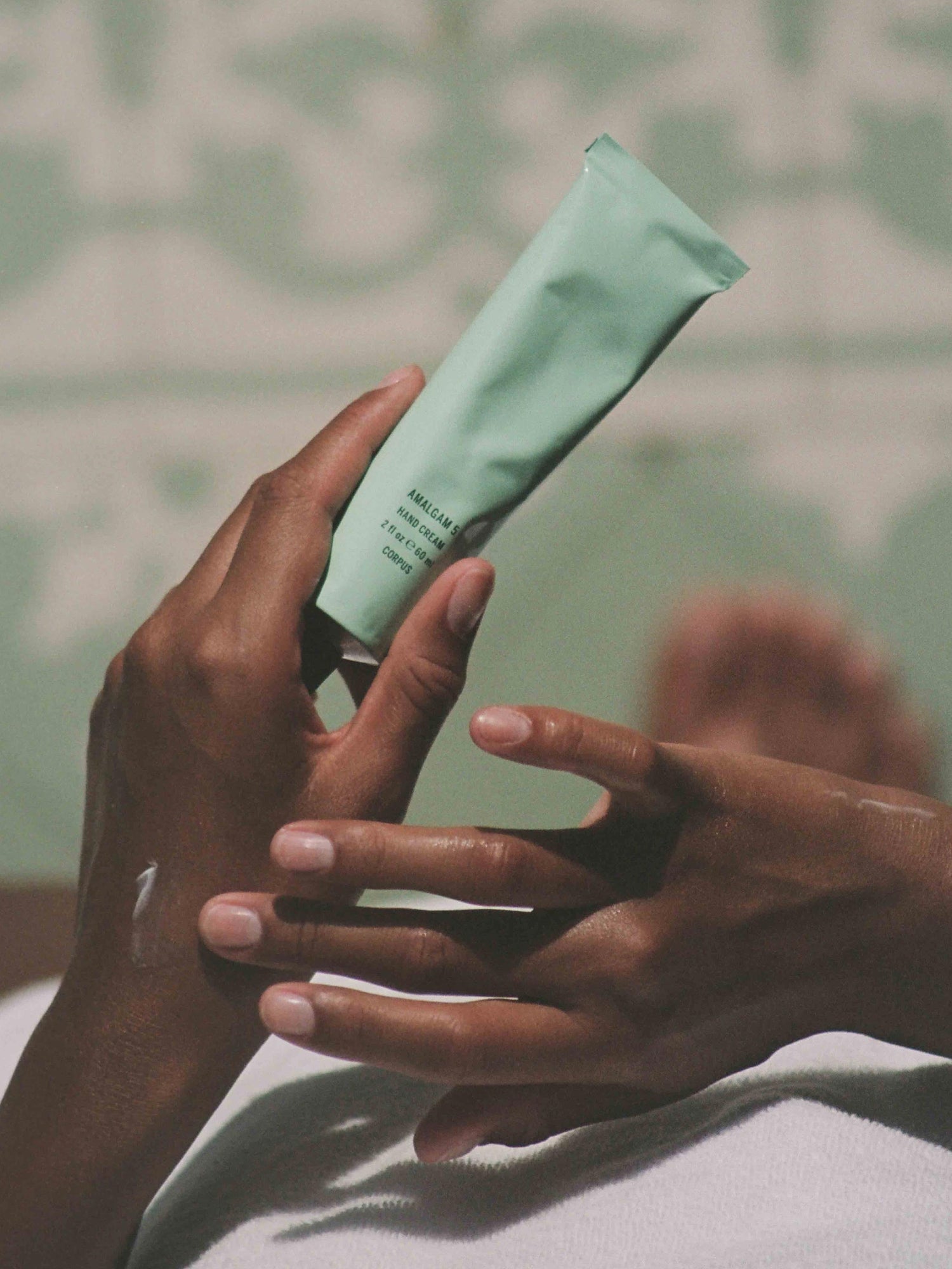Corpus Aromatic Hand Cream held in hand