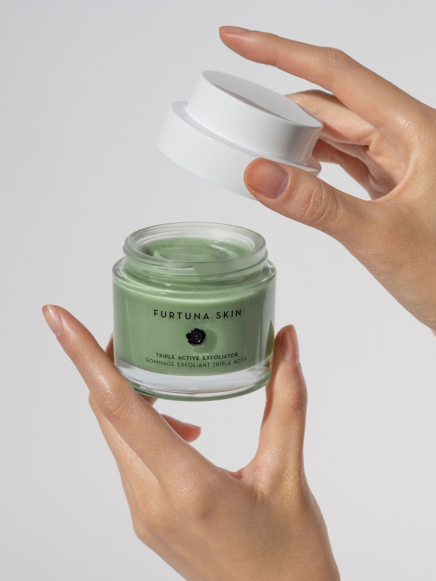 Furtuna Skin Triple Active Exfoliator 80 ml jar held in hands