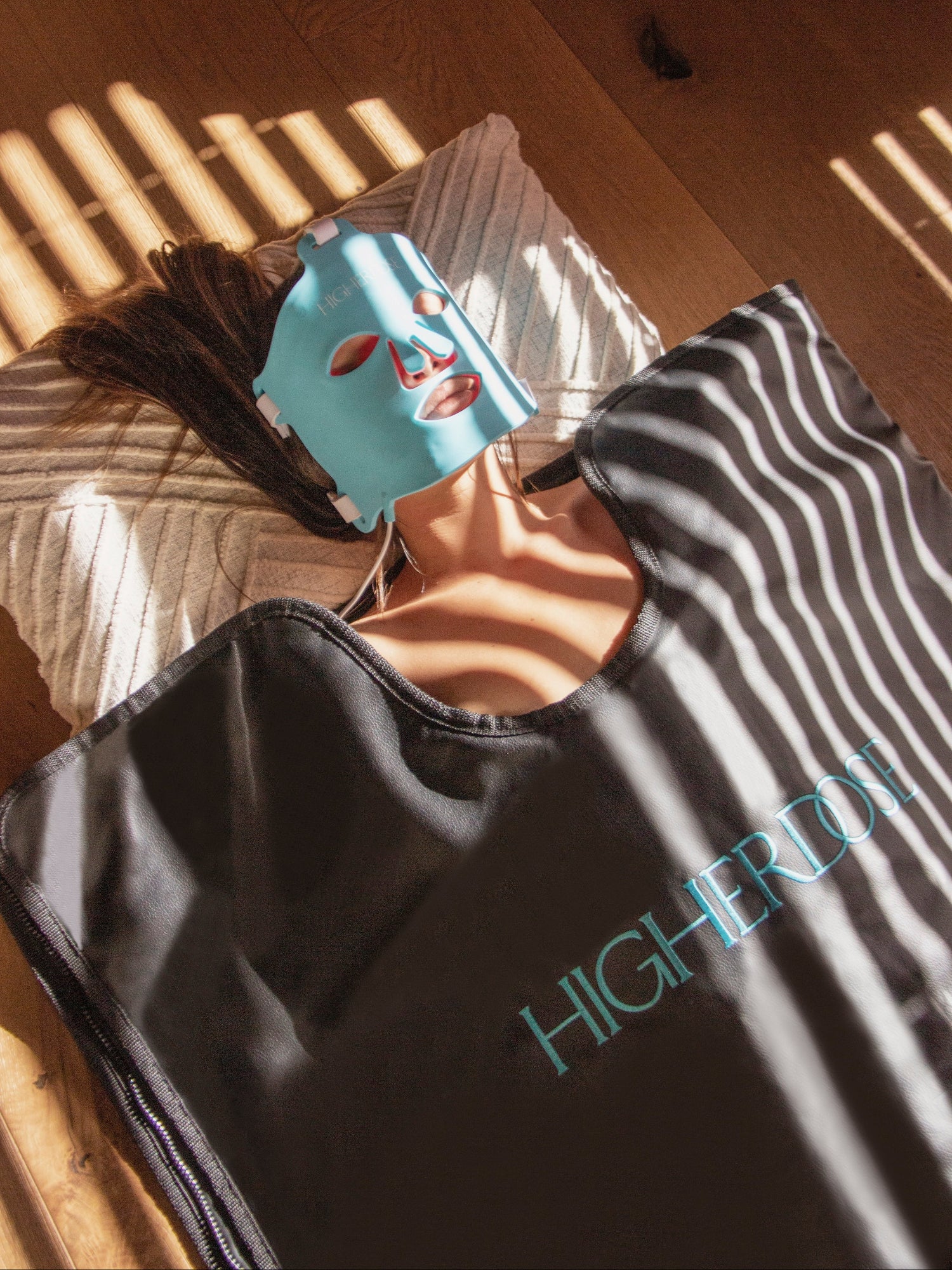HIGHERDOSE Infrared Sauna Blanket with woman relaxing at home
