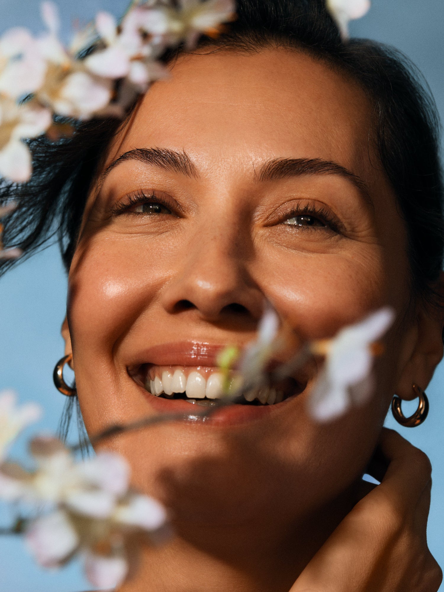 Woman with glowing skin using IRENE FORTE Almond Cleansing Milk