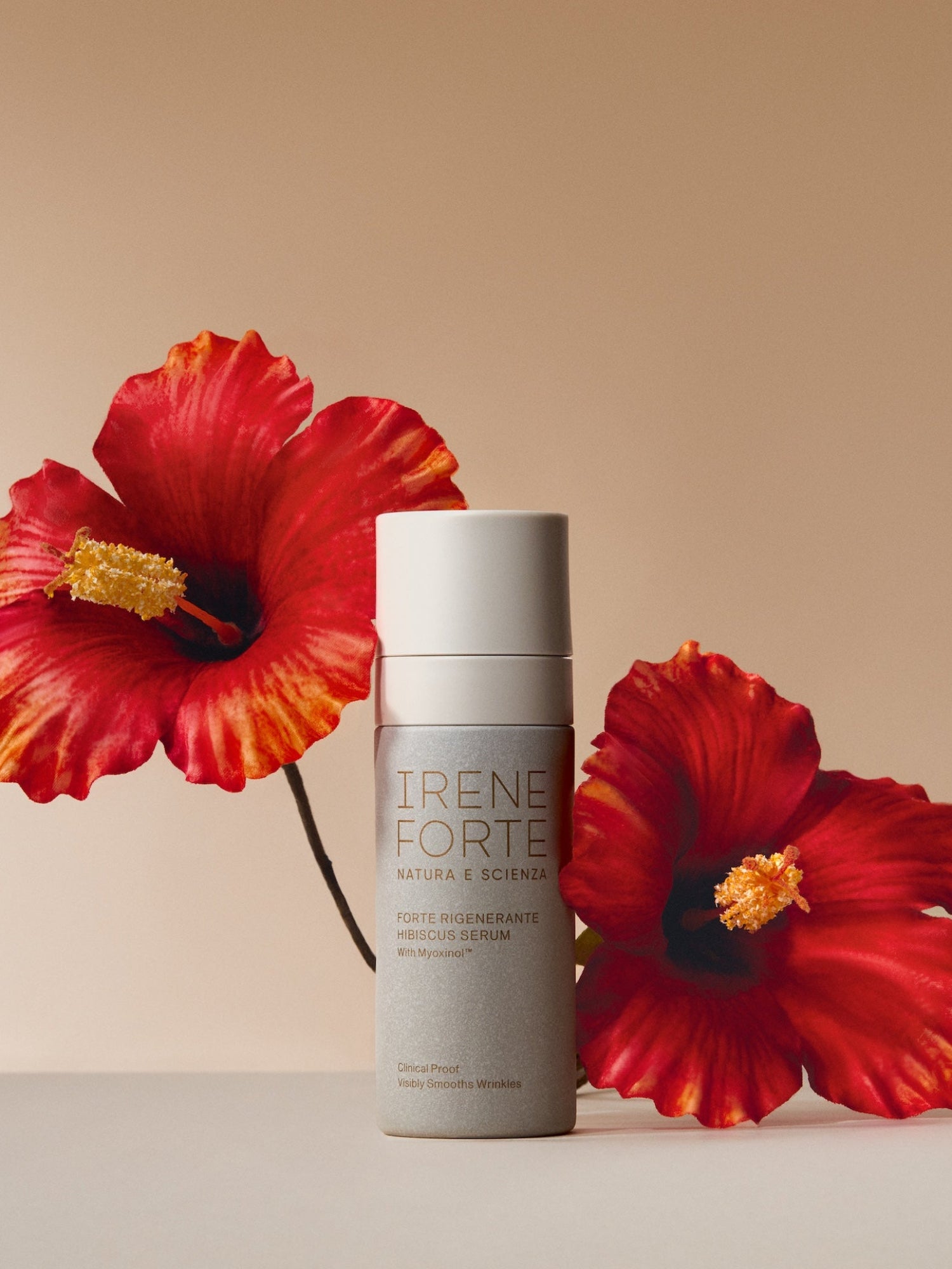Woman with glowing skin using IRENE FORTE Hibiscus Serum