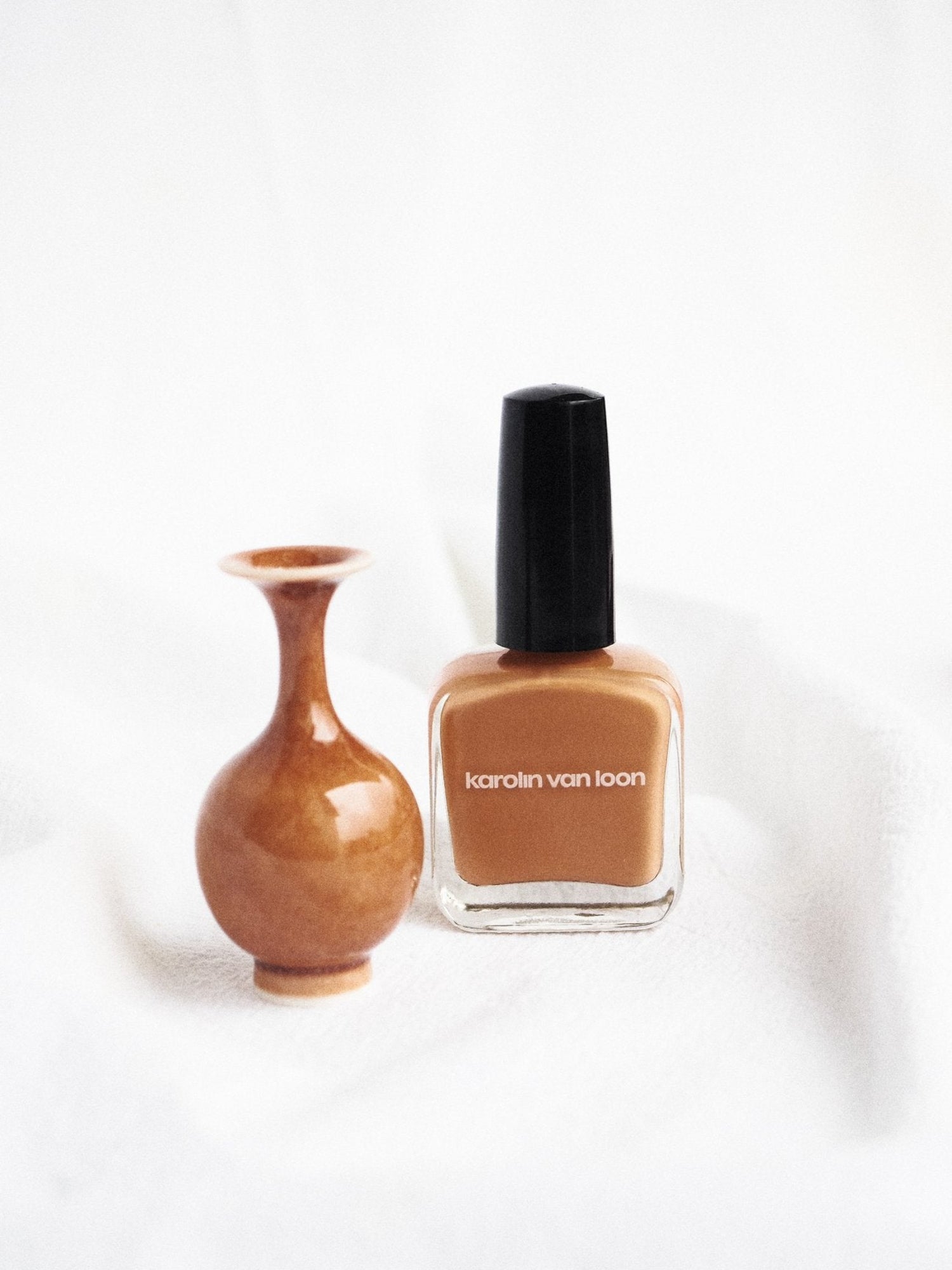 Karolin Van Loon Zinia Orange Nail Polish lifestyle image with decorative vas