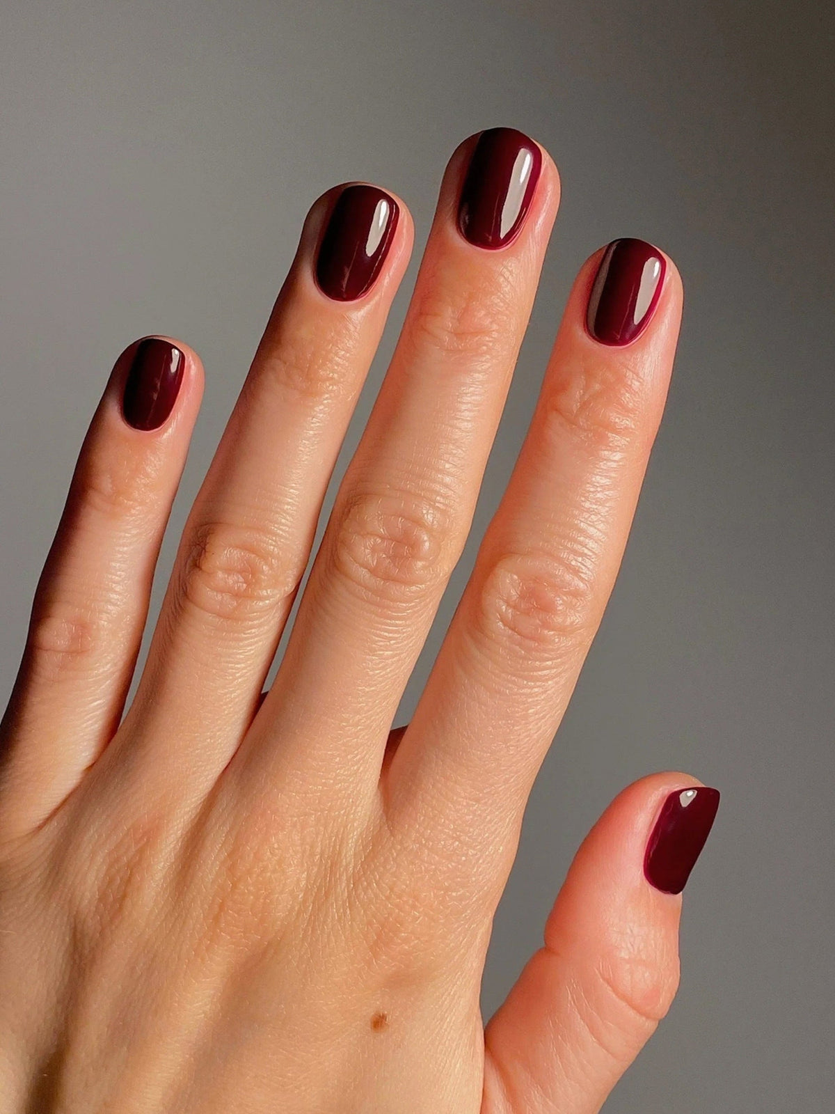 KAROLIN VAN LOON Rouge Royale deep red nail polish on nails