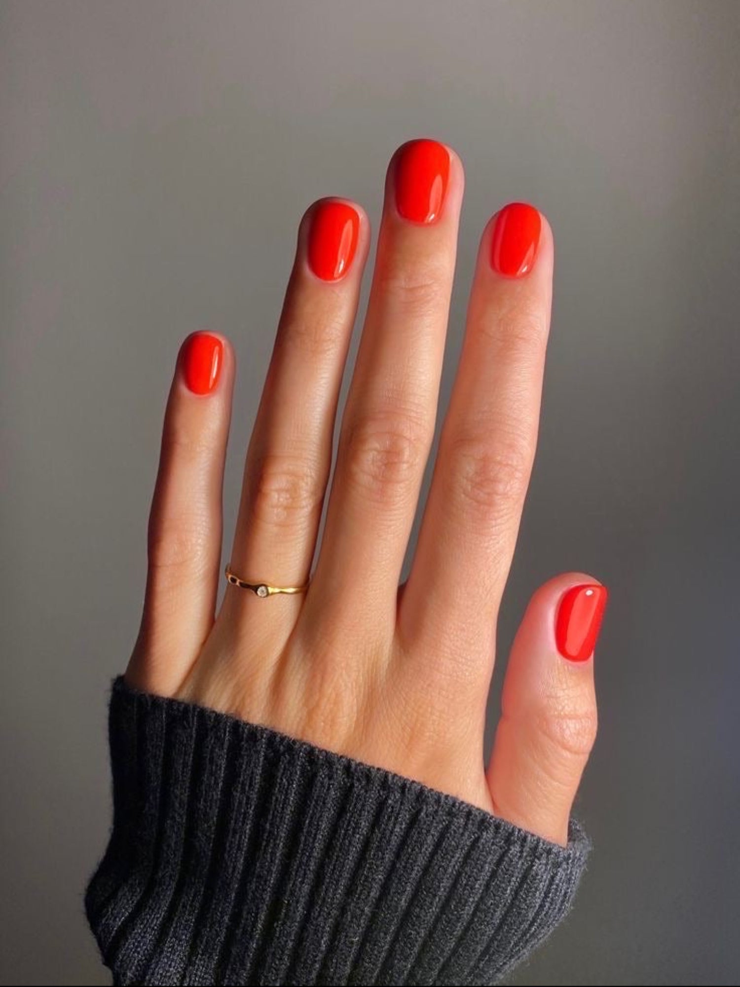 KAROLIN VAN LOON Rouge Solaire vibrant red nail polish on hand