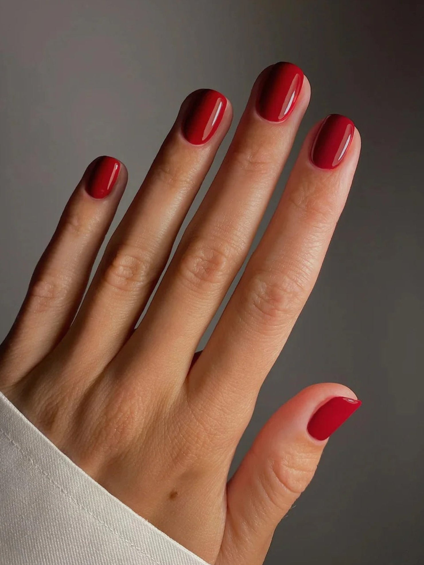 KAROLIN VAN LOON Rouge Eclipse red nail polish on nails