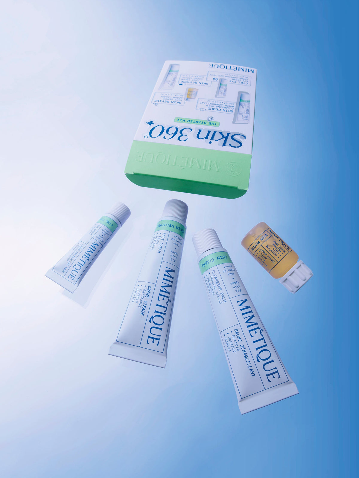 MIMÉTIQUE Skin 360° The Starter Kit Lifestyle all products falling out of package above them, sky blue background