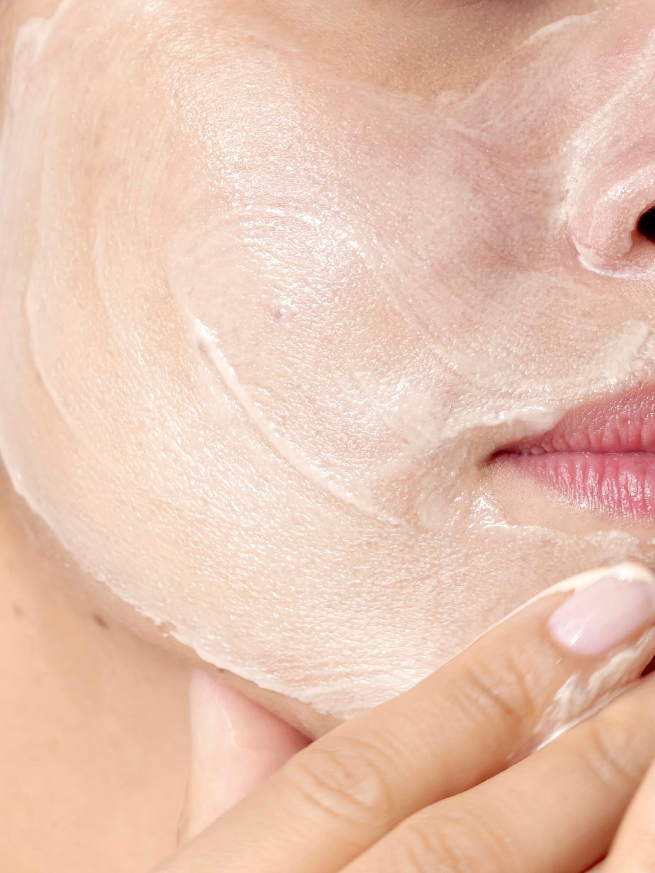 Texture of the MIMÉTIQUE Skin Cloud Nourishing Cleansing Balm shown on a model's cheek