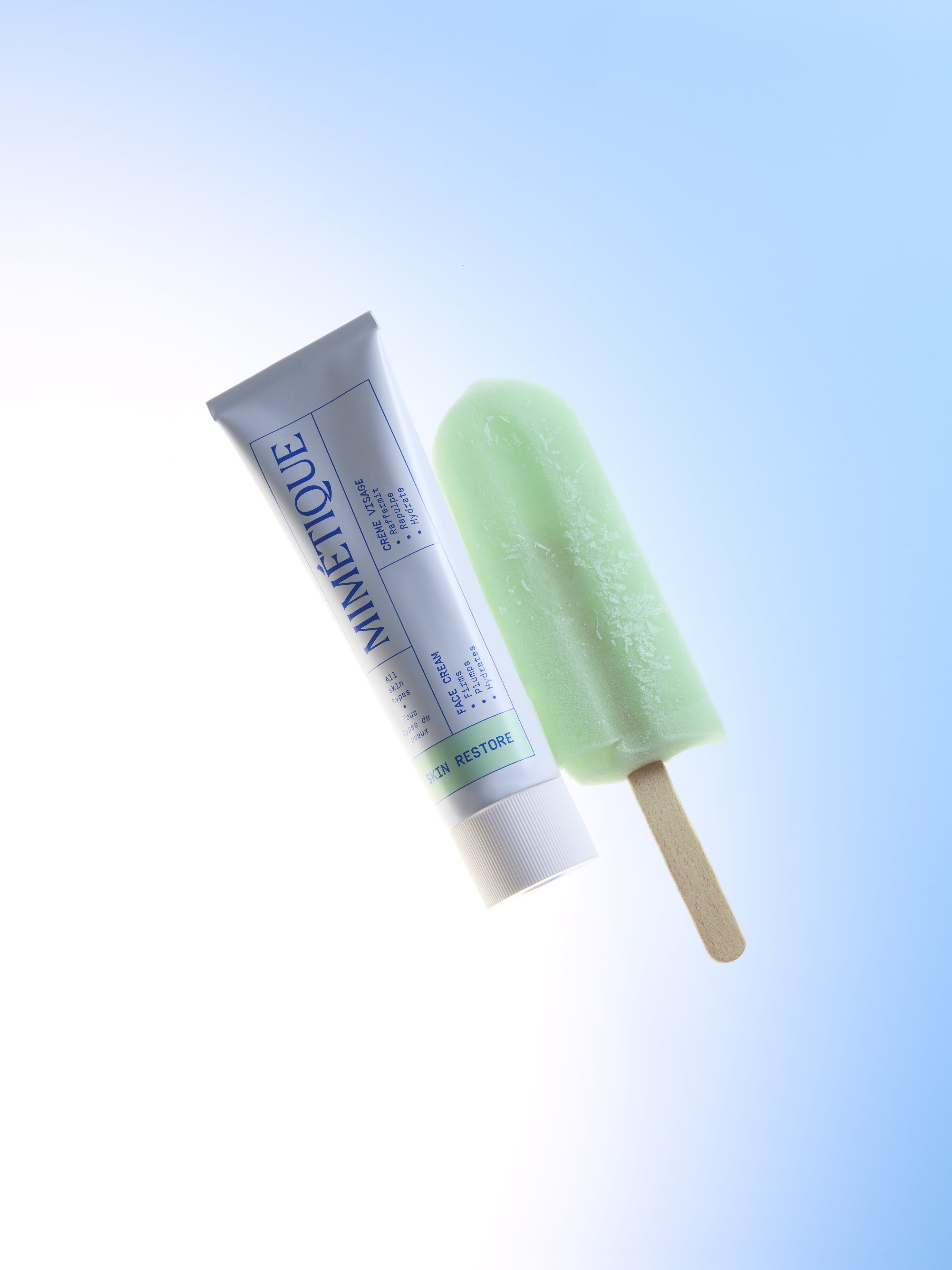 A tube of MIMÉTIQUE Skin Restore Plumping Face Cream and a light green ice cream 