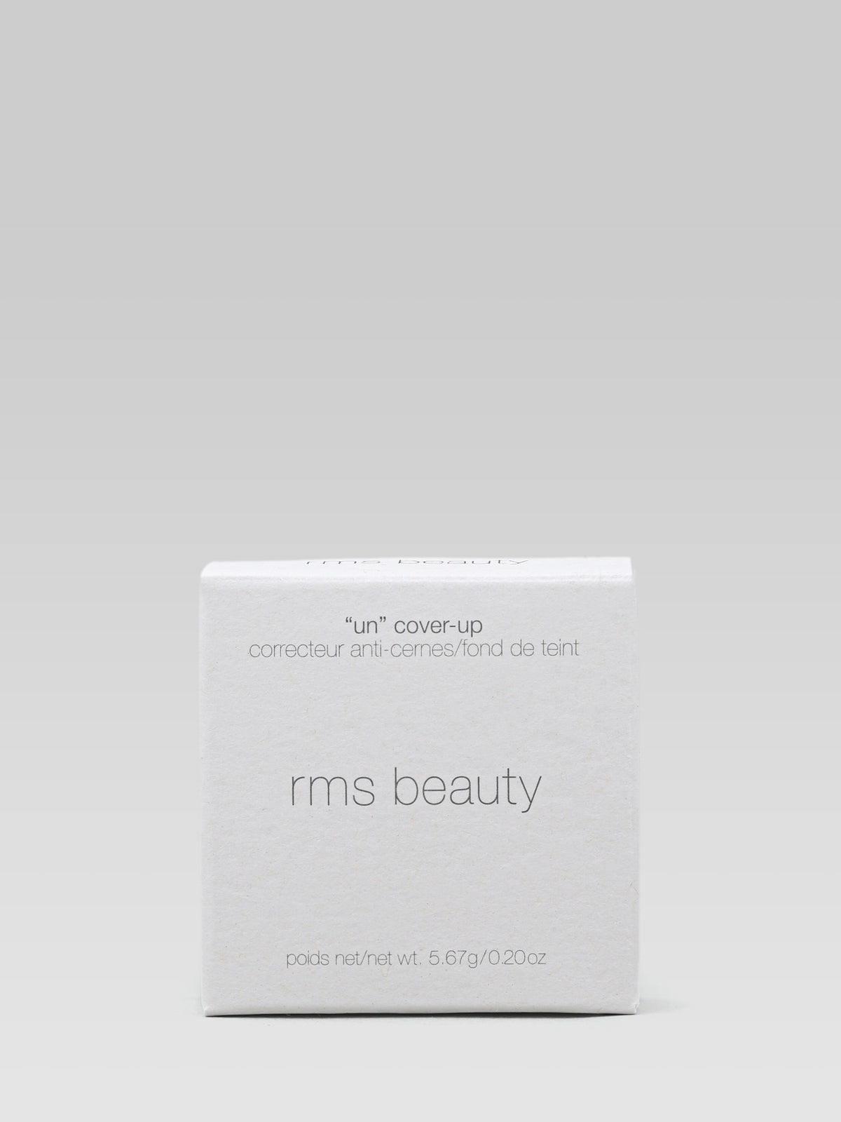 RMS Beauty UnCoverup Concealer packaging in a white minimalist cardboard box with grey lettering, photographed against a light grey background