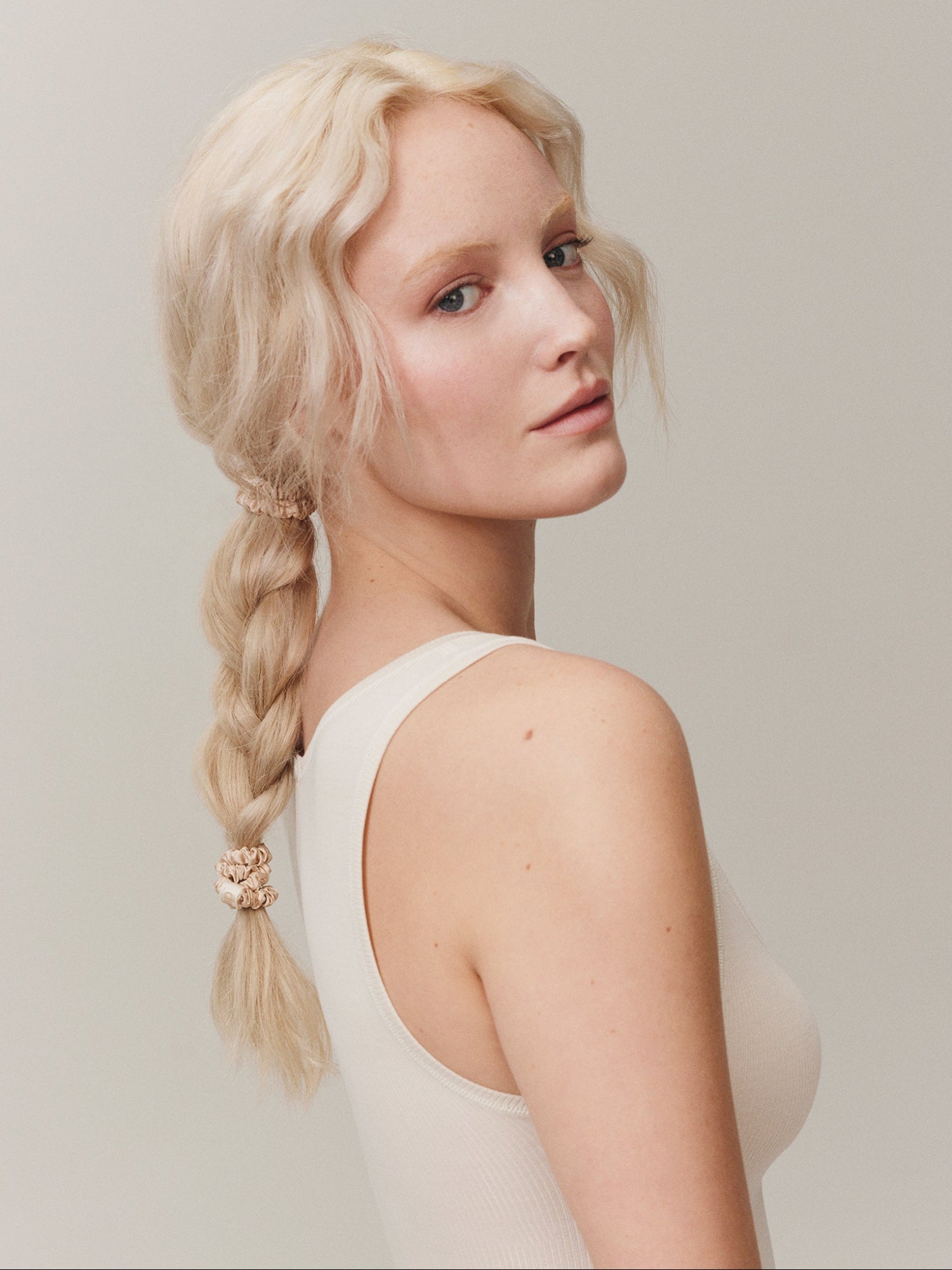 SLIP Back To Basics Skinny Scrunchies in Blonde – woman wearing a blonde silk scrunchie in braided hair
