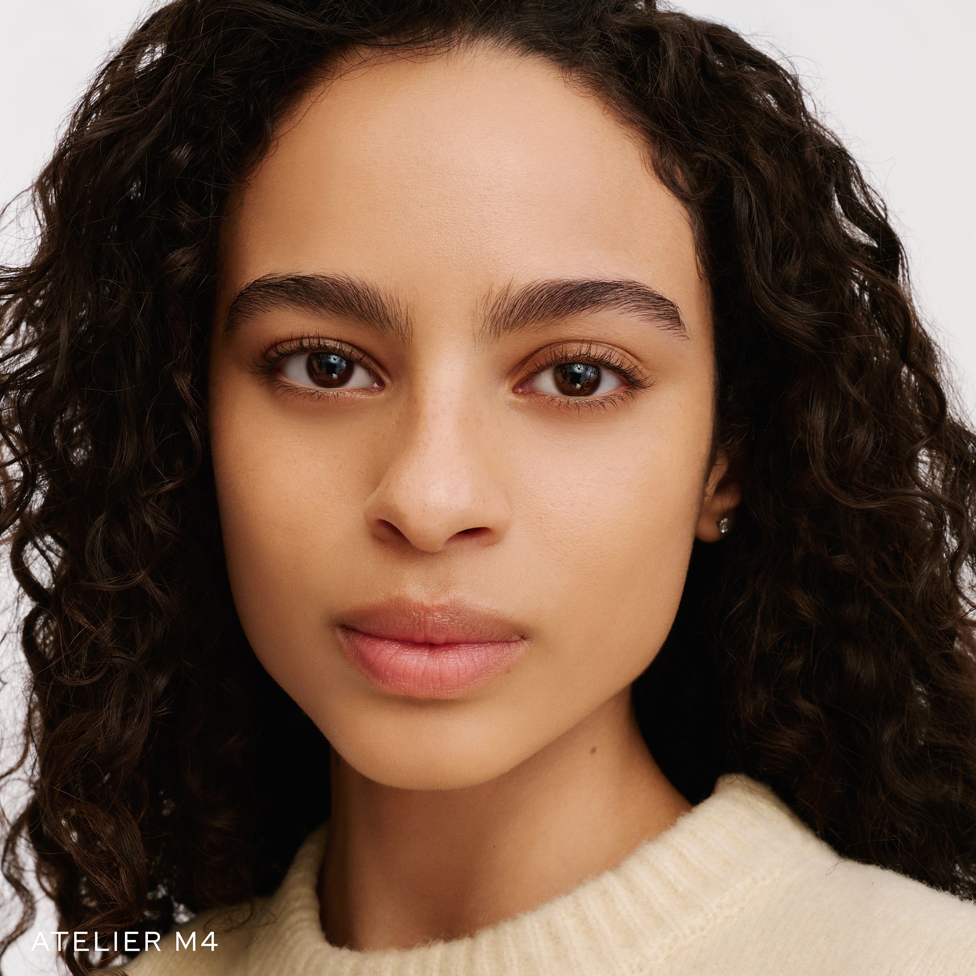 The Face of a Model wearing the WESTMAN ATELIER Suprême Bio-Complex Liquid Foundation in the shade  M4