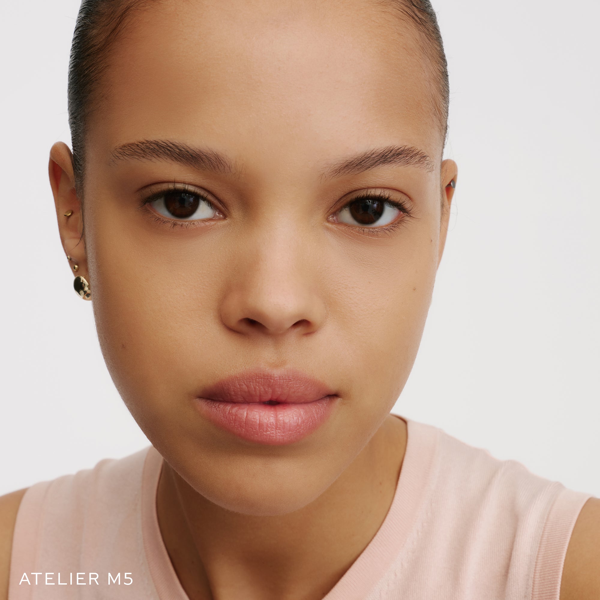 The Face of a Model wearing the WESTMAN ATELIER Suprême Bio-Complex Liquid Foundation in the shade  M5