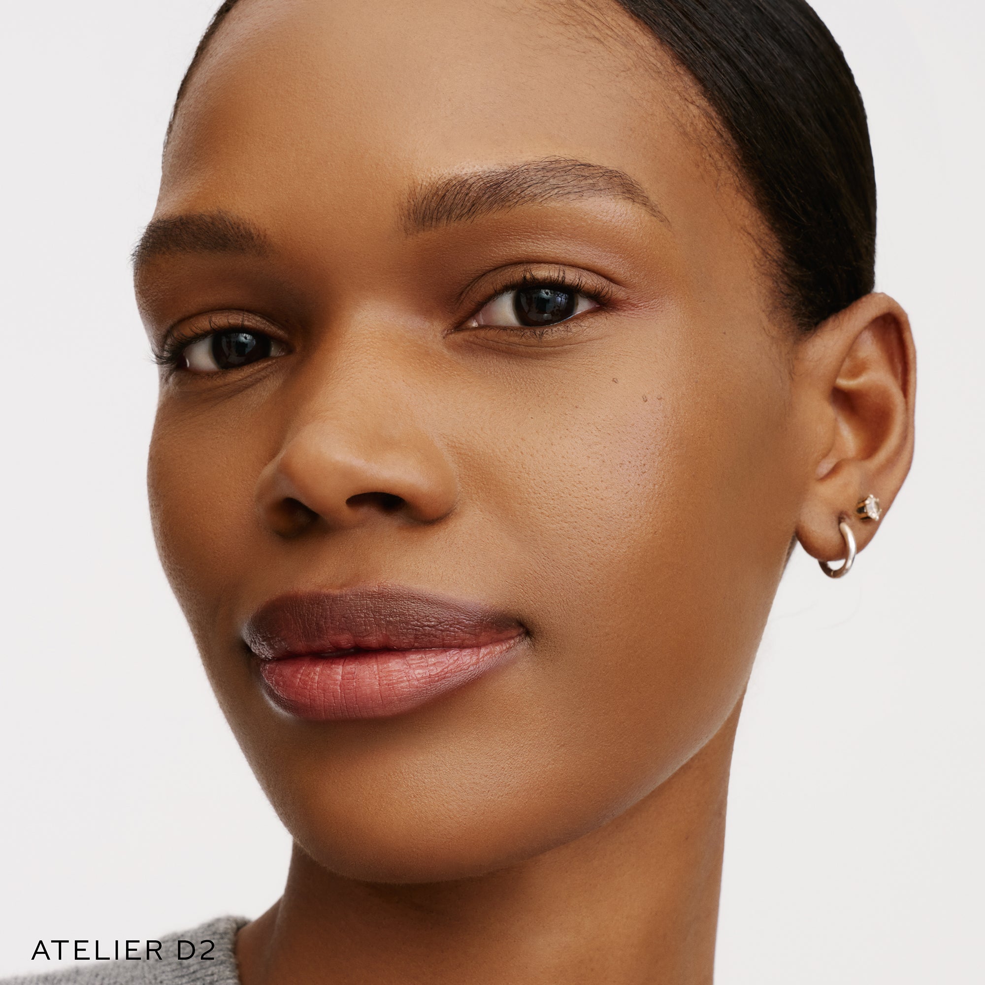 The Face of a Model wearing the WESTMAN ATELIER Suprême Bio-Complex Liquid Foundation in the shade D2