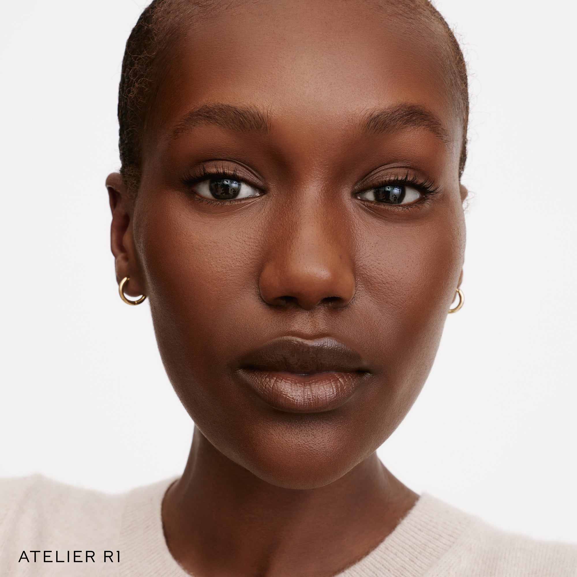 The Face of a Model wearing the WESTMAN ATELIER Suprême Bio-Complex Liquid Foundation in the shade R1