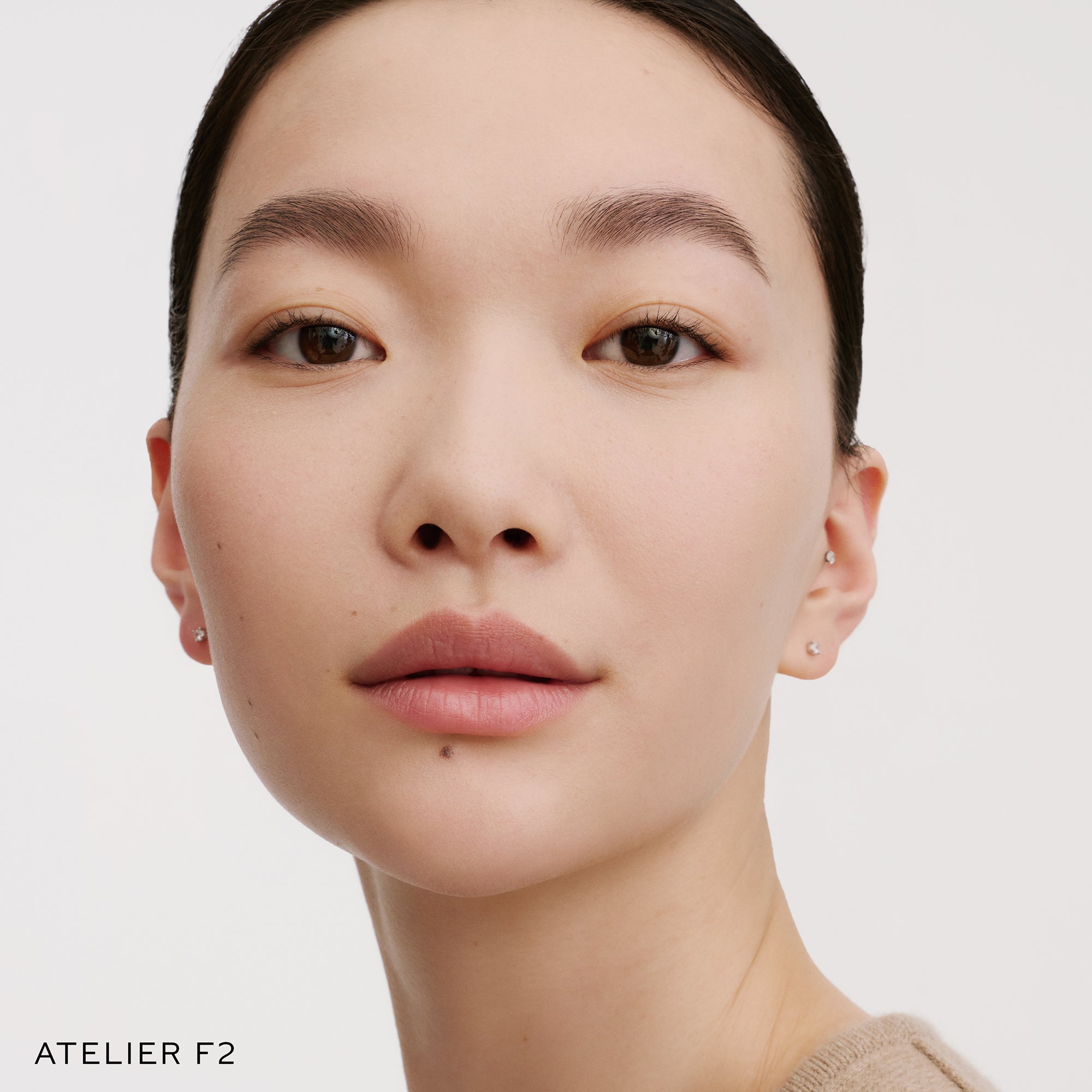 The Face of a Model wearing the WESTMAN ATELIER Suprême Bio-Complex Liquid Foundation in the shade F2