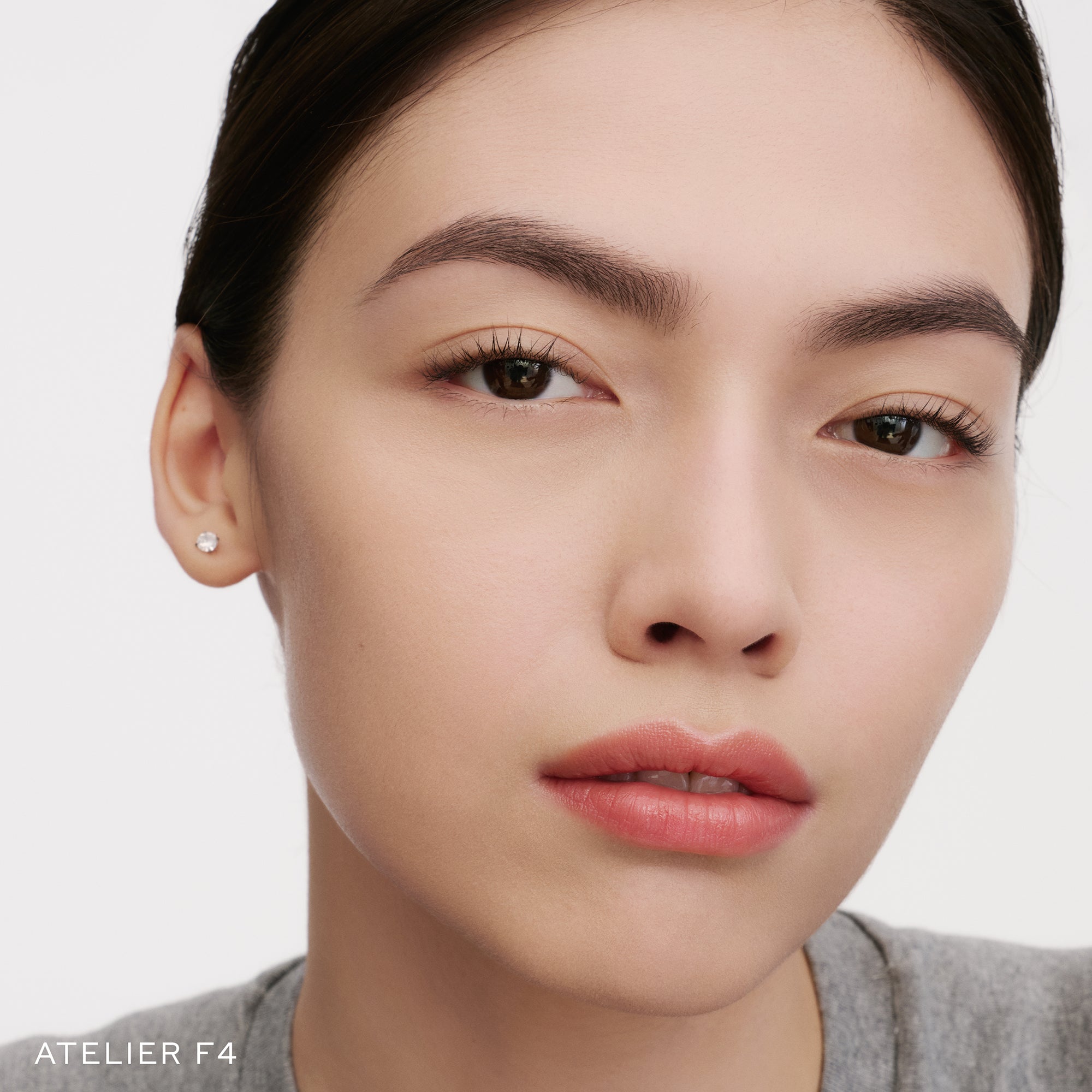 The Face of a Model wearing the WESTMAN ATELIER Suprême Bio-Complex Liquid Foundation in the shade F14