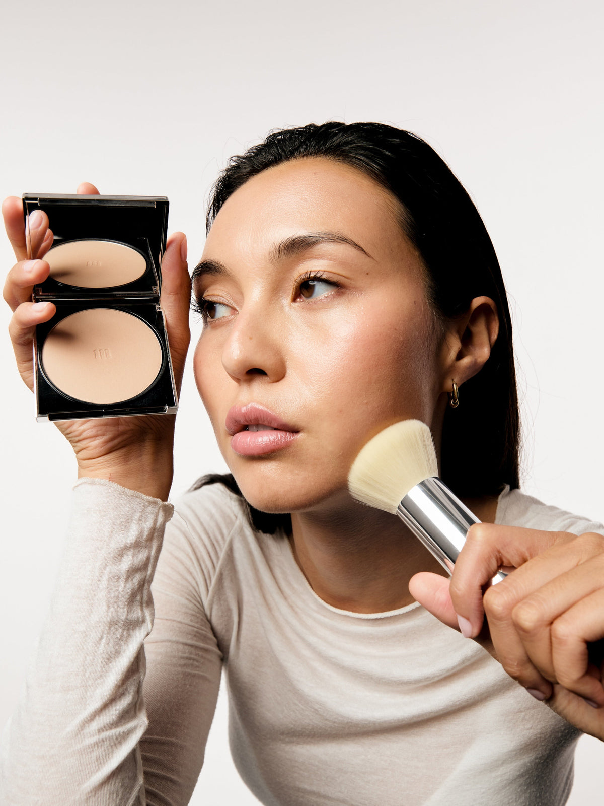 AIME Skincare Powder Foundation SPF 30 applied with a makeup brush