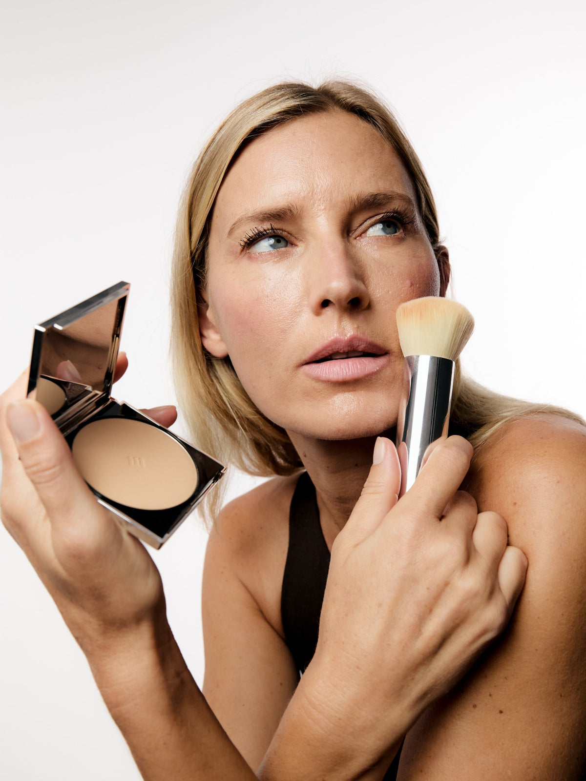 AIME Skincare Powder Foundation SPF 30 applied with a makeup brush