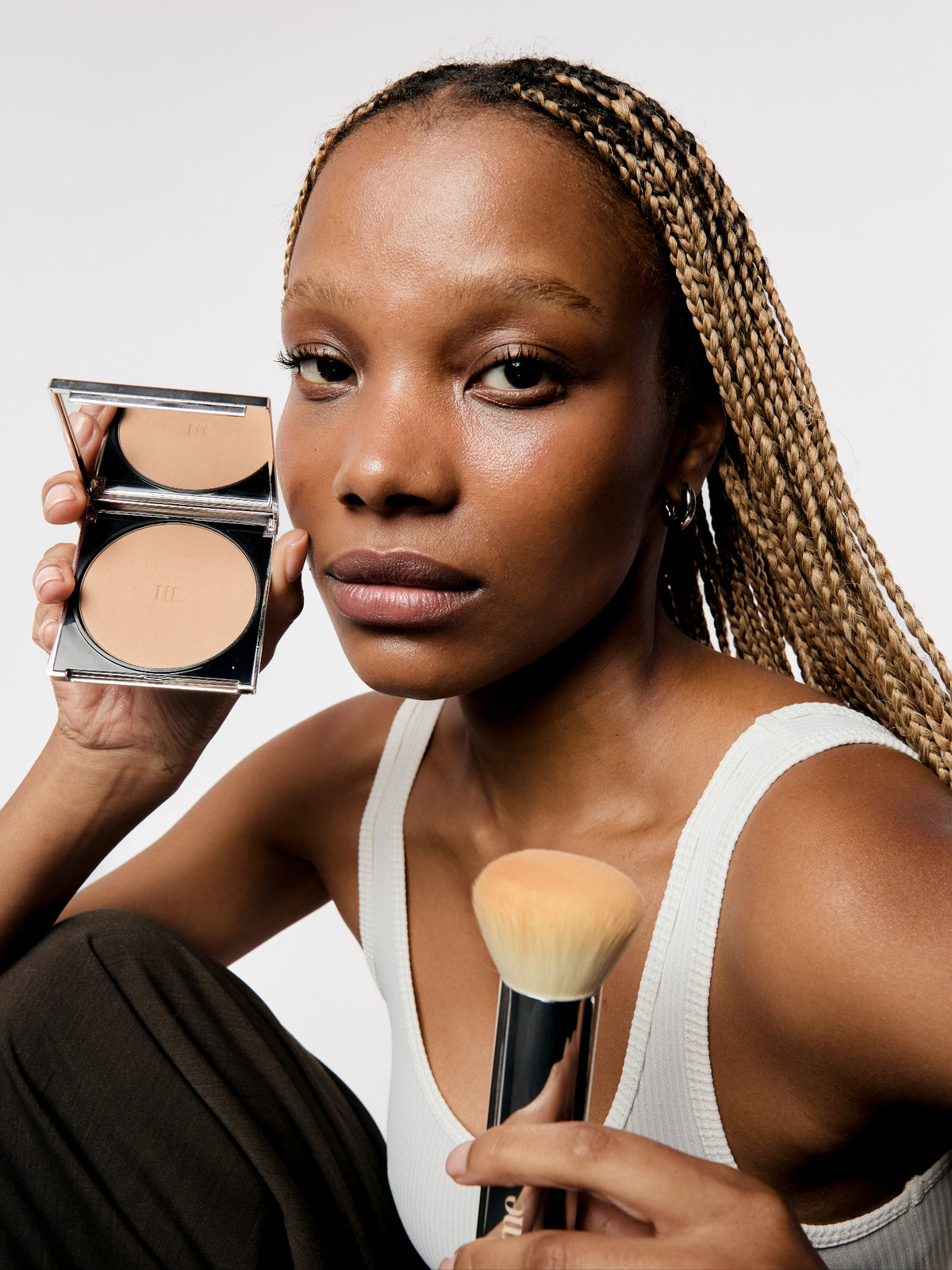 AIME Skincare Powder Foundation SPF 30 with makeup brush on model
