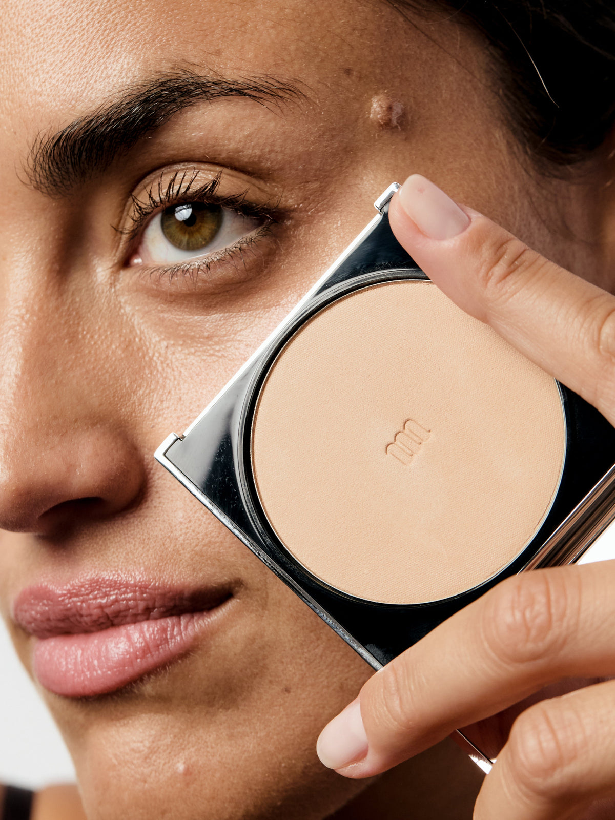 AIME Skincare Powder Foundation SPF 30 held next to face