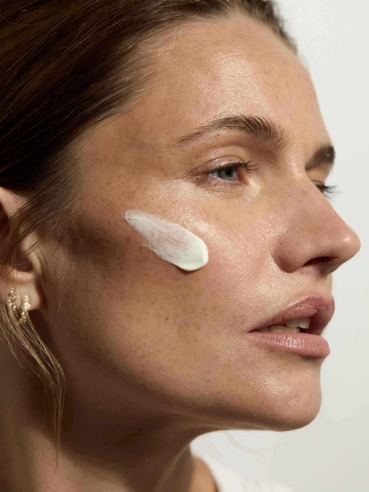 AIME The Daily SPF SPF50 UVA+UVB sunscreen applied to skin