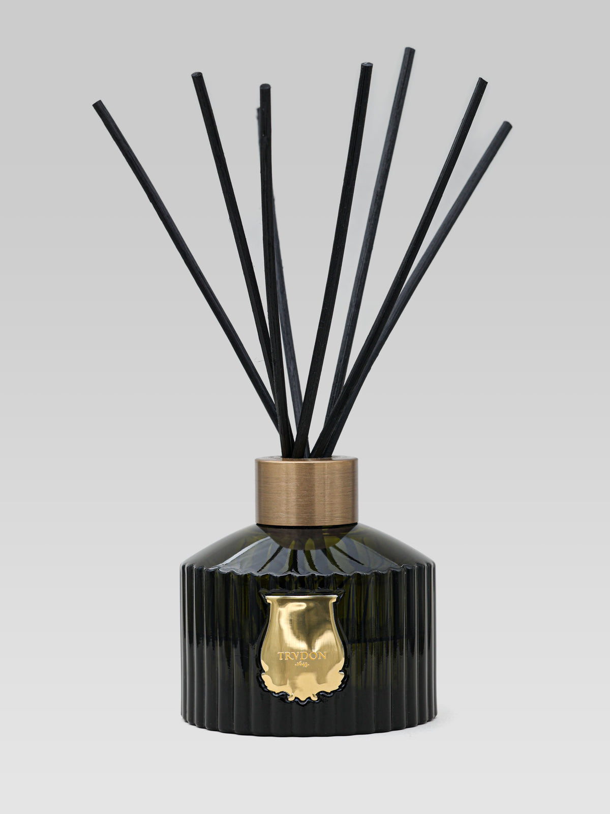 Cire Trudon Cyrnos reed diffuser with black fragrance reeds in glass bottle