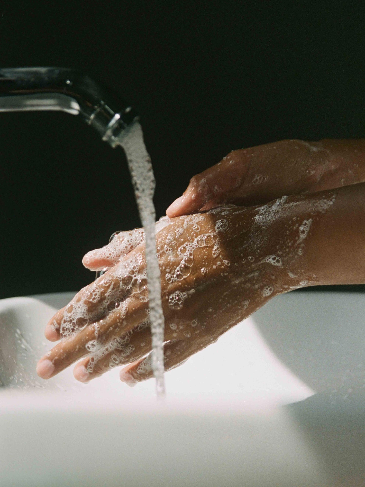 Corpus Aromatic Hand Wash used on hands under running water