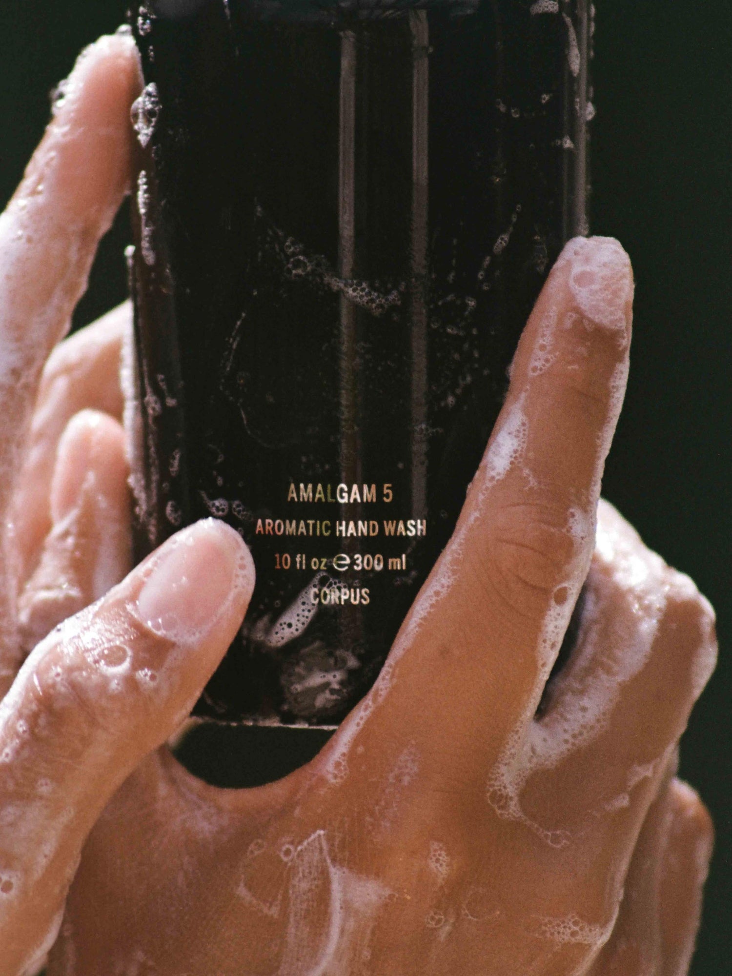 Corpus Aromatic Hand Wash held in soapy hands