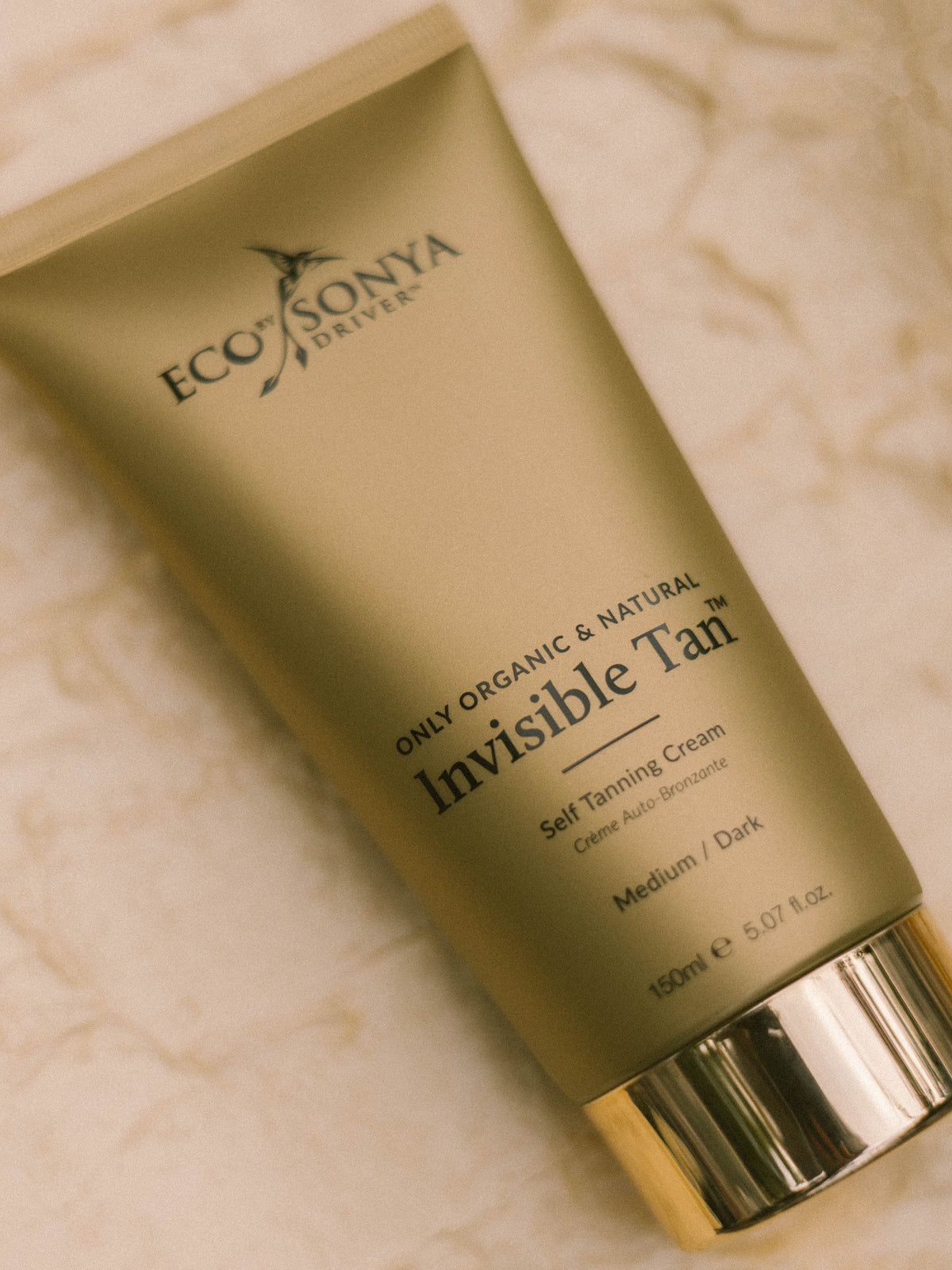 Eco by Sonya Invisible Tan self-tanning cream on marble surface
